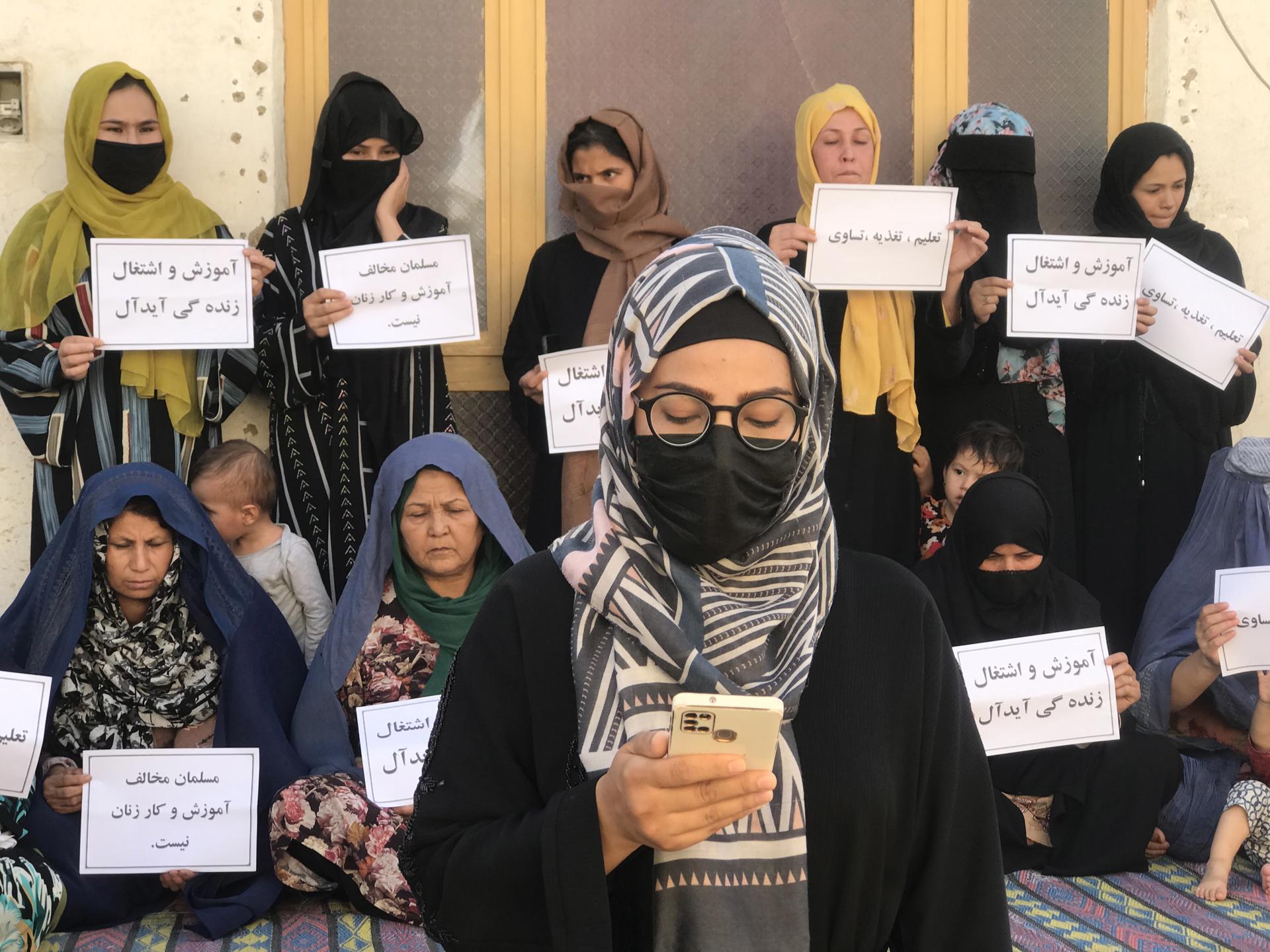 Afghan women hold placards reading in Dari 'A Muslim can't go against women's education and work', during a protest as they demand their right to education and work in Mazar-e-Sharif, Afghanistan, 16 August 2023. EFE/EPA/STR