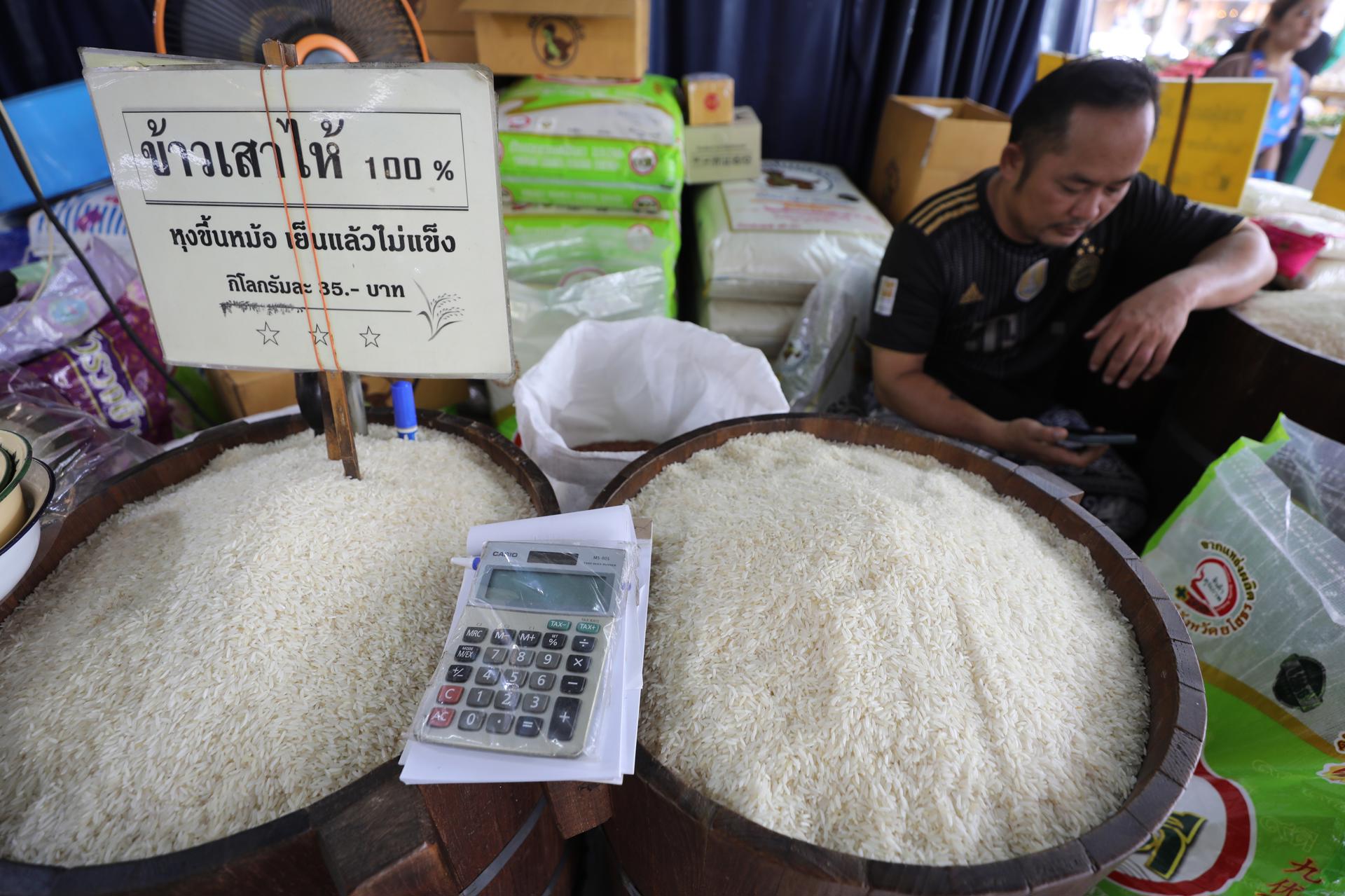 A rice shop worker awaits customers at a market in Bangkok, Thailand, 13 August 2023. The Thai Rice Exporters Association revealed that the price of Thai rice in exports shot up 100 US dollars per metric ton in a month, after India banned rice exports from 20 July 2023, to reduce domestic rice prices and increase supply. EFE/EPA/NARONG SANGNAK