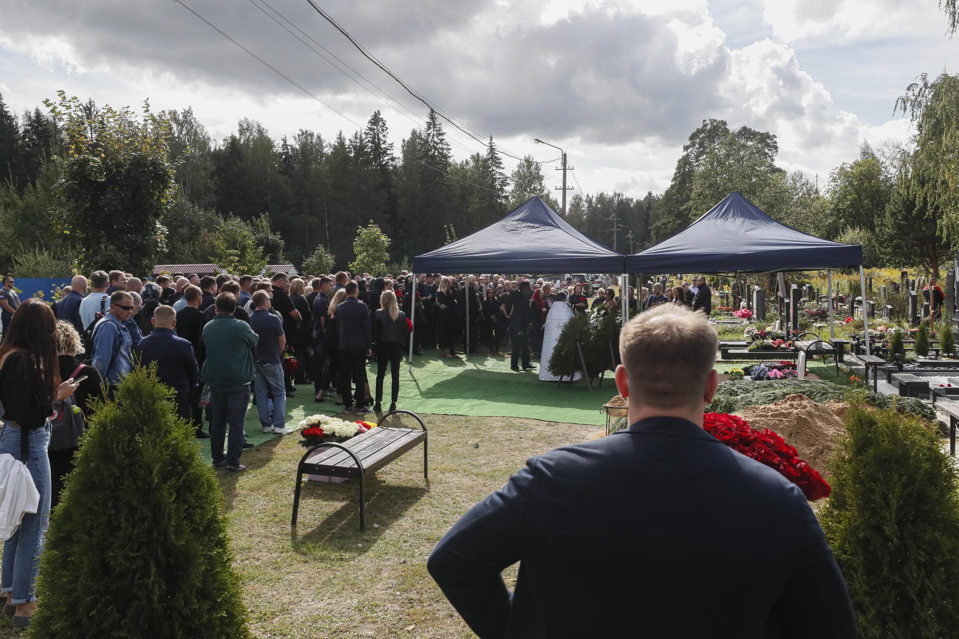 People gather near the coffin with body of the Wagner Group chief Valery Chekalov, killed in a plane crash, during funeral on the Severnoye cemetery in St. Petersburg, Russia, 29 August 2023. EFE-EPA/ANATOLY MALTSEV