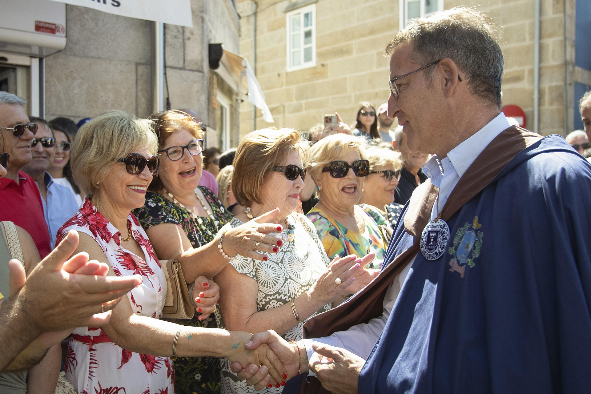 El presidente del PP, Alberto Núñez Feijóo saluda a unas mujeres durante la LXXI Festa do Albariño celebrado en Cambados, Pontevedra, este domingo. EFE/Salvador Sas
