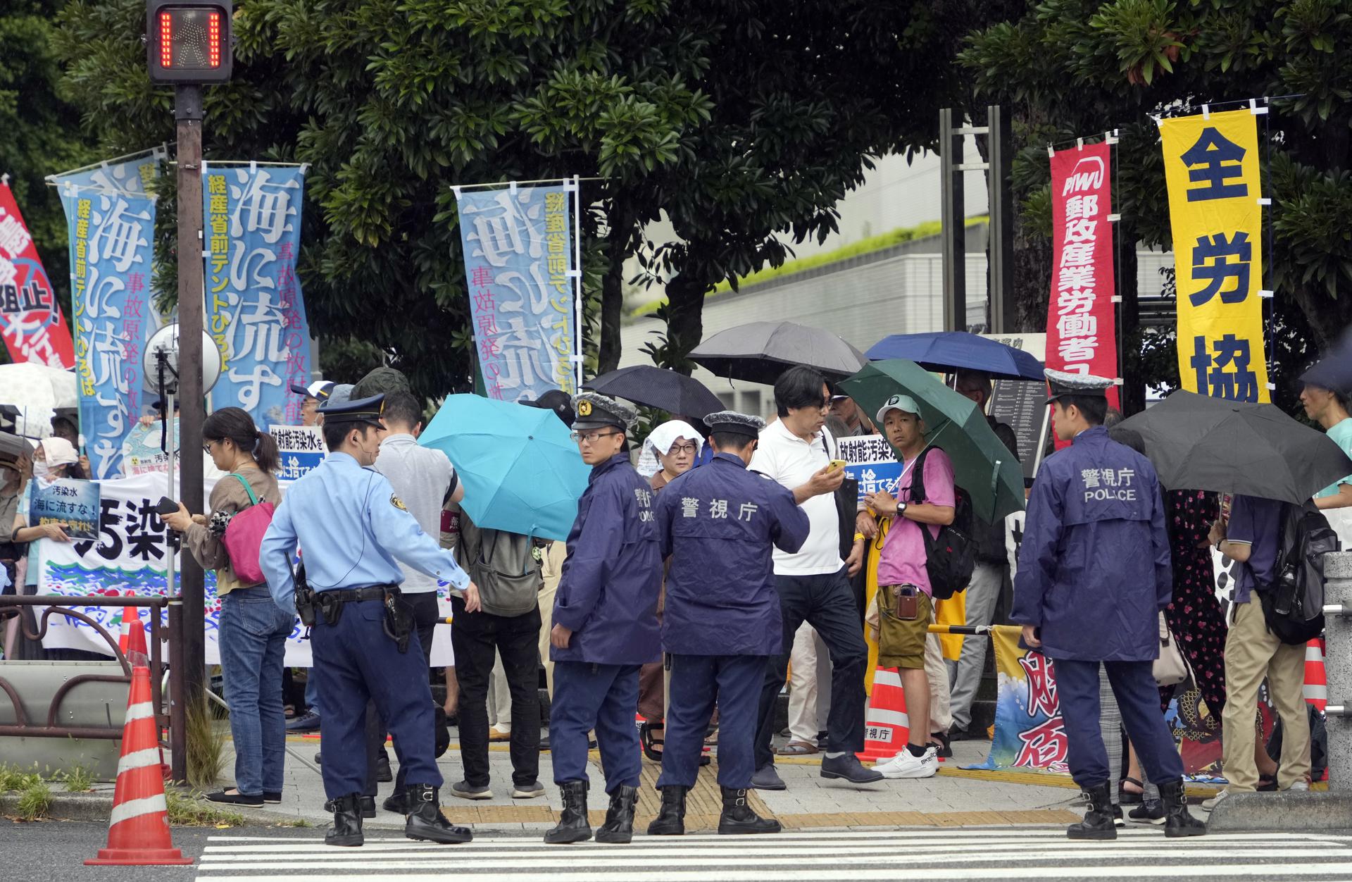 Policemen stand before protesters during a rally in front of the Prime Minister's official residence as Prime Minister Fumio Kishida was holding a ministerial meeting about the release of treated water from the crippled Fukushima nuclear power plant into the sea, in Tokyo, Japan, 22 August 2023. EFE-EPA/FRANCK ROBICHON
