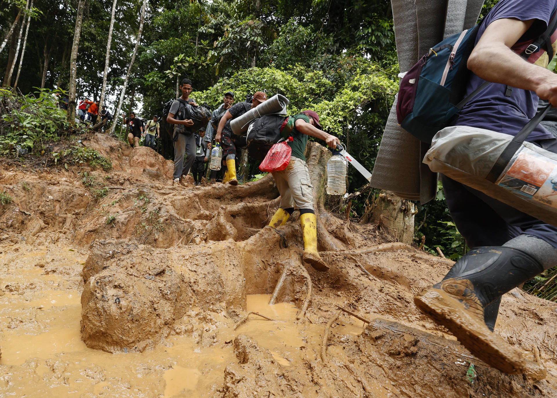 Migrants descend a muddy mountain in the Darién Gap, Colombia, on Oct. 8, 2022. EFE FILE/Mauricio Duenas Castañeda
