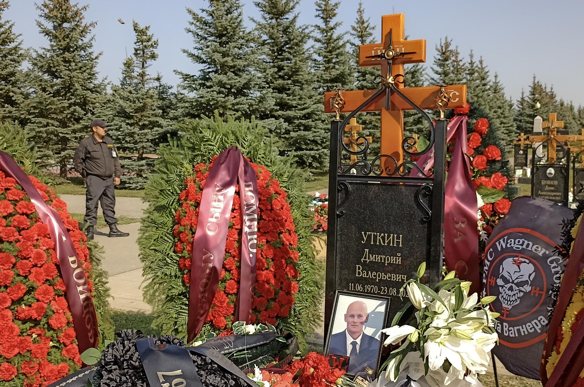 A security guard stands beside the grave of PMC Wagner group's alleged co-founder and military commander Dmitry Utkin, killed in a plane crash in Tver region, at the Federal Military Memorial Cemetery in Mytishchi, Moscow region, Russia, 31 August 2023. EFE-EPA/MAXIM SHIPENKOV
