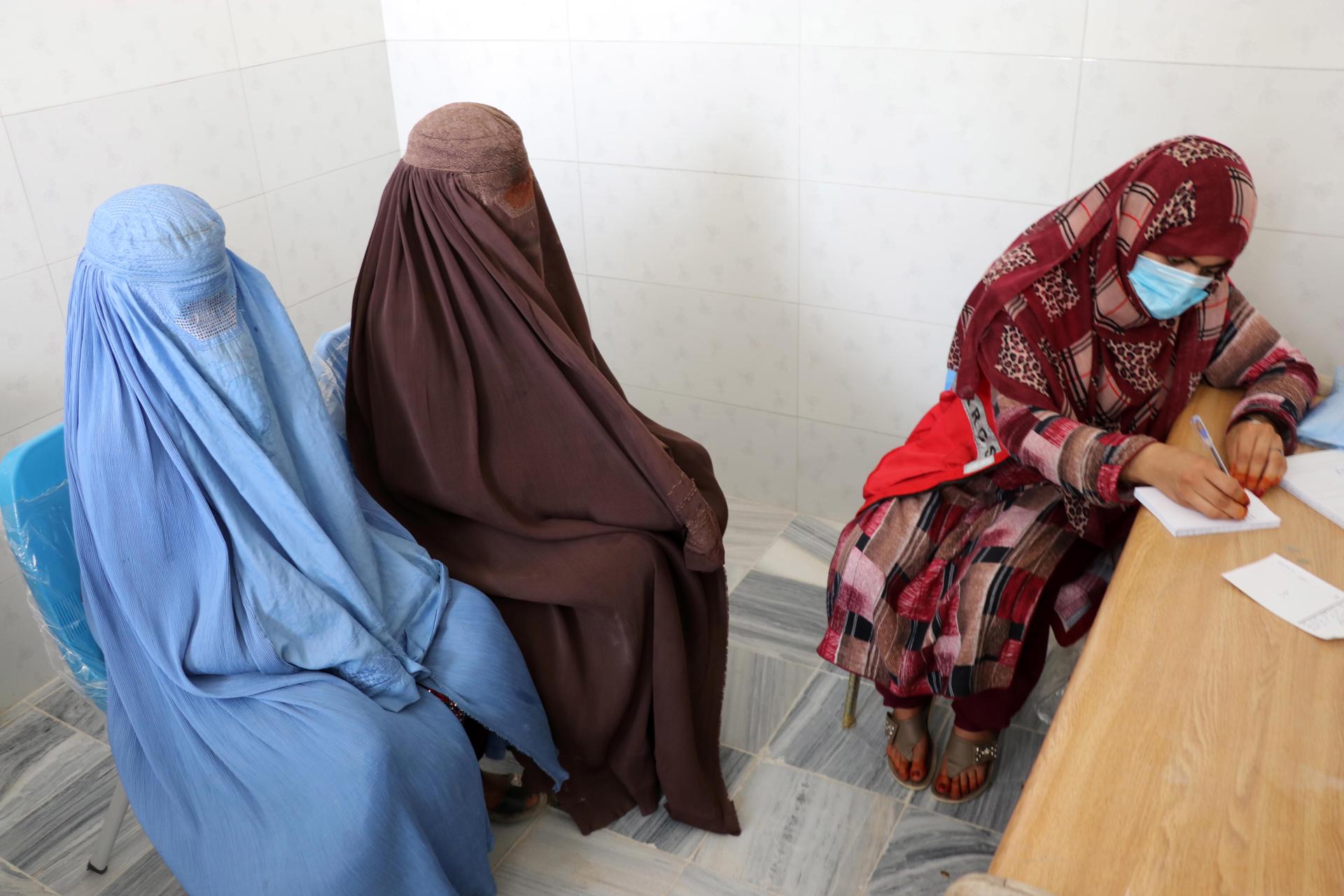 Fatima, a government midwife, writes down as she attends to patients in the government hospital in Panjawai district, Kandahar, Afghanistan, 06 April 2023 (issued 07 April 2023). EFE-EPA FILE/STRINGER