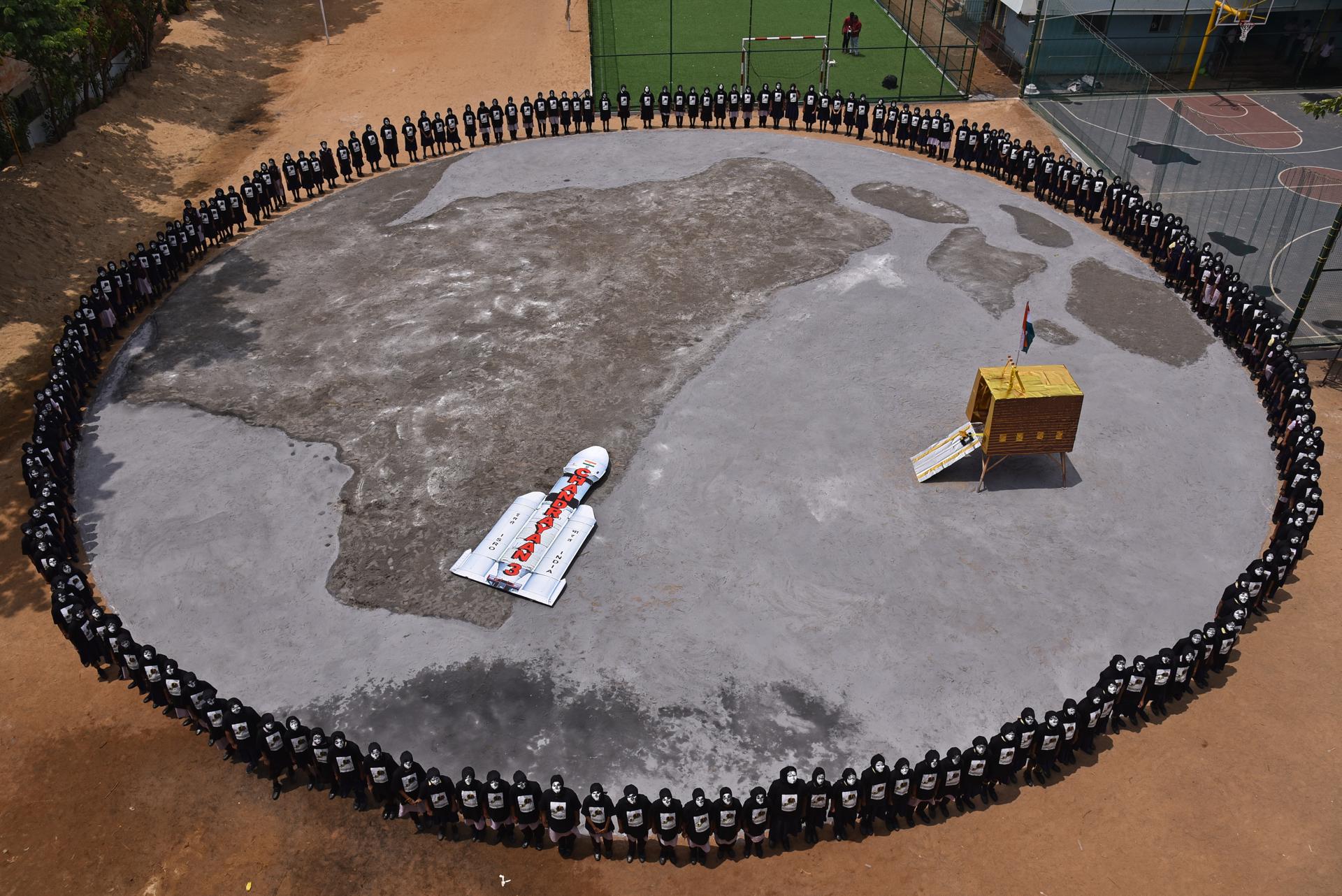 Indian students form a circle around a model of the Indian Space Research Organisation's (ISRO) mission Chandrayaan-3 to celebrate its attempt to land on the moon, in Chennai, India, 22 August 2023. EFE-EPA/IDREES MOHAMMED