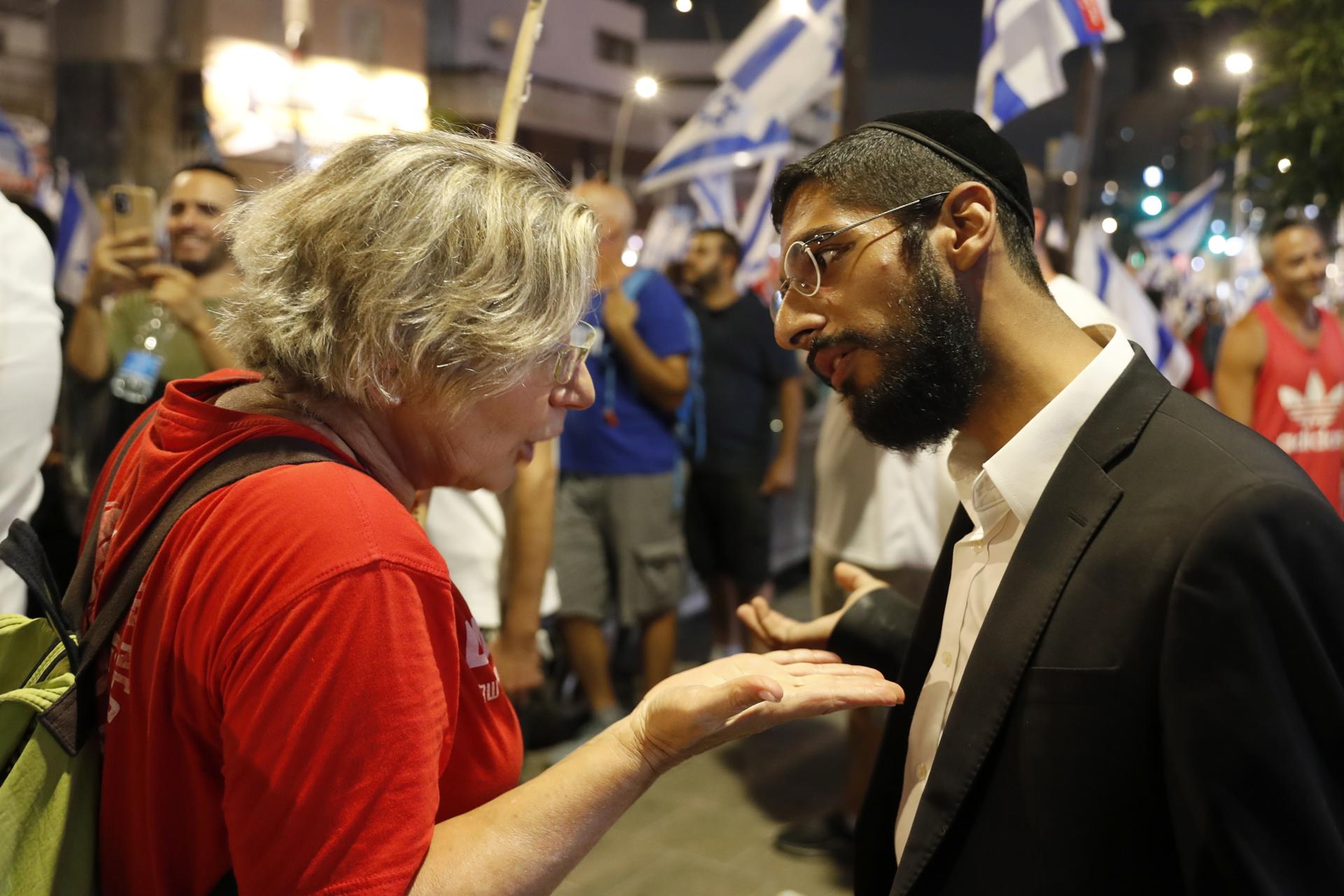 An Ultra-Orthodox Jewish man argues with a protester during an anti-Government women's rights protests in the orthodox city of Bnei Brak, Israel, on 24 August 2023. EFE-EPA/ATEF SAFADI
