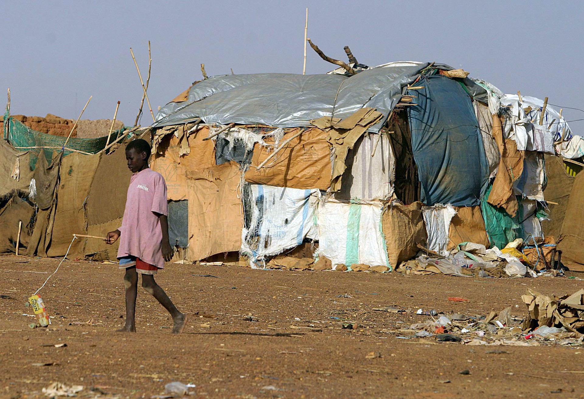A Sudanese boy walks through the impoverished Wad el Bashier camp for internally displaced persons on the outskirts of Khartoum, Sudan Sunday 10 October 2004. EPA/FILE/NIC BOTHMA