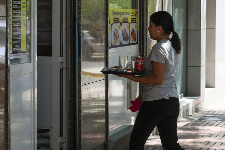 Una camarera retira un servicio en una cafetería de Madrid.