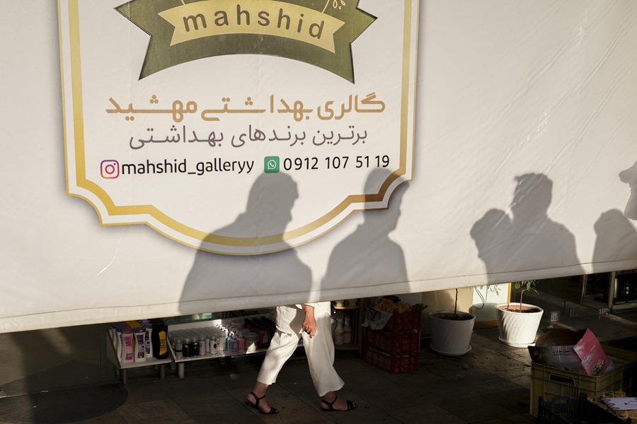 A woman walks in the Tajrish Square bazaar 