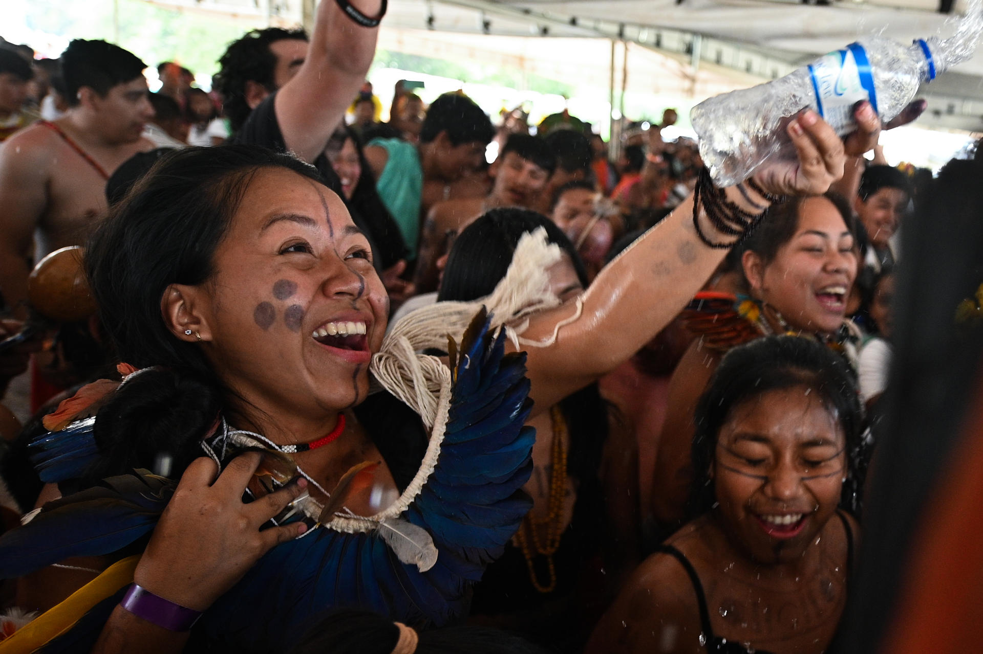Indigenous people celebrate the favorable vote during the transmission of the Temporary Framework trial on a screen installed in front of the Supreme Federal Court, in Brasilia, Brazil, on September 21 2023. EFE/ Andre Borges