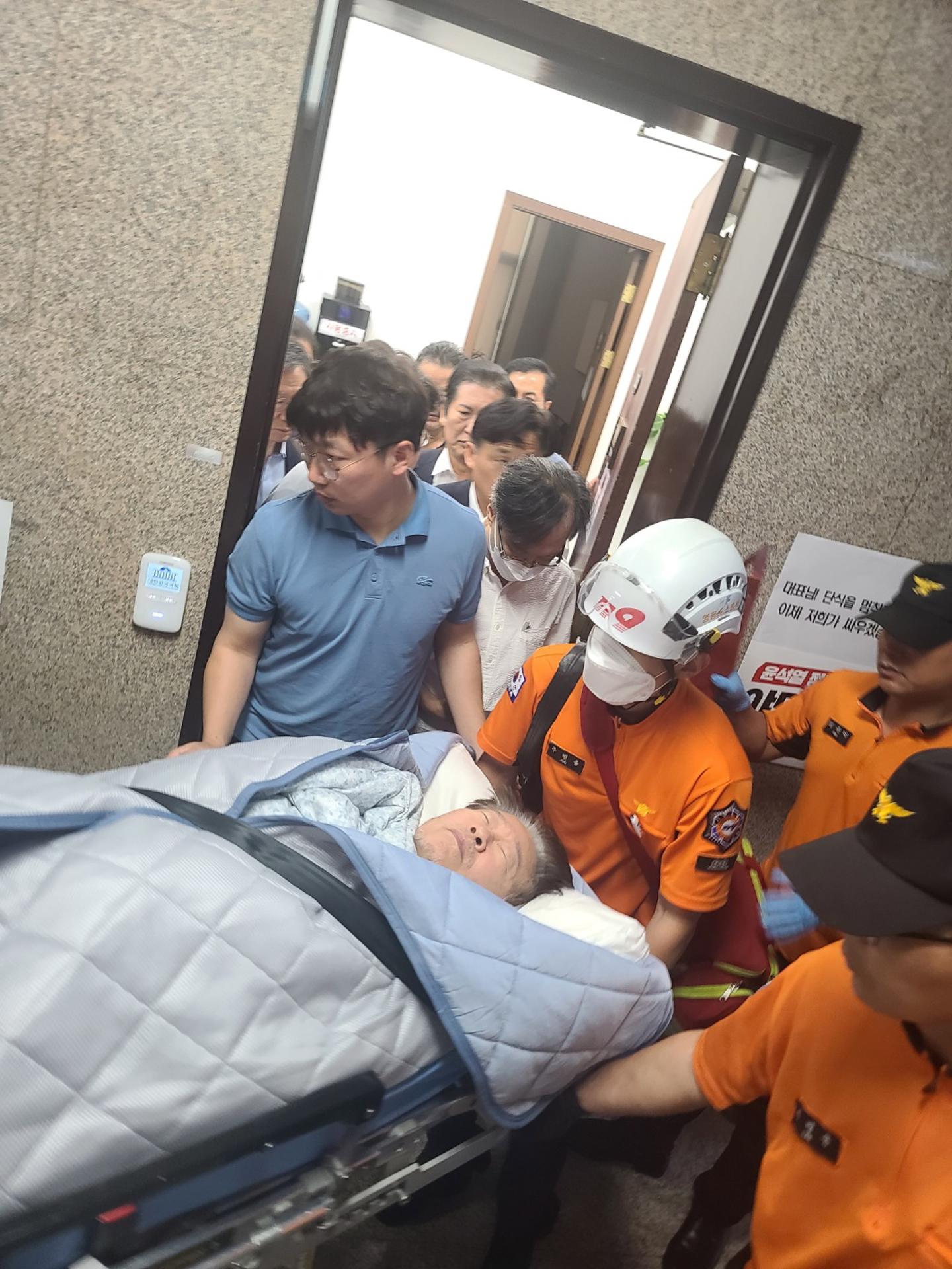 Rescue workers move Lee Jae-myung, head of the main opposition Democratic Party, on a stretcher from his office at the National Assembly in Seoul, South Korea, 18 September 2023 to a nearby hospital due to deteriorating health conditions on the 19th day of his hunger strike there. EFE-EPA/YONHAP SOUTH KOREA OUT