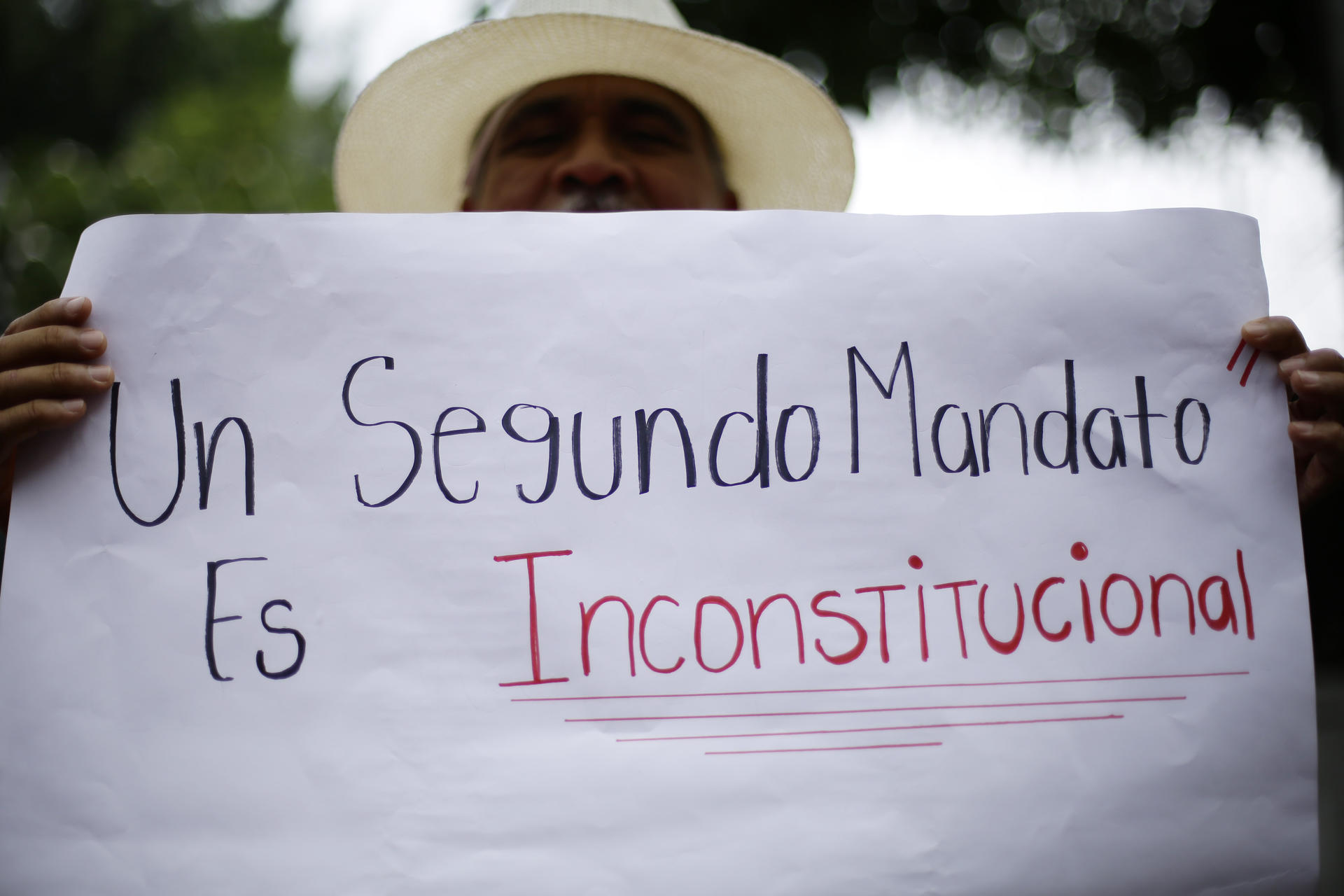 Unions, civil society organizations, students and human rights representatives march in commemoration of International Labor Day, in San Salvador, El Salvador, on May 1, 2023, with this sign reading "a second term is unconstitutional." EFE FILE/Rodrigo Sura
