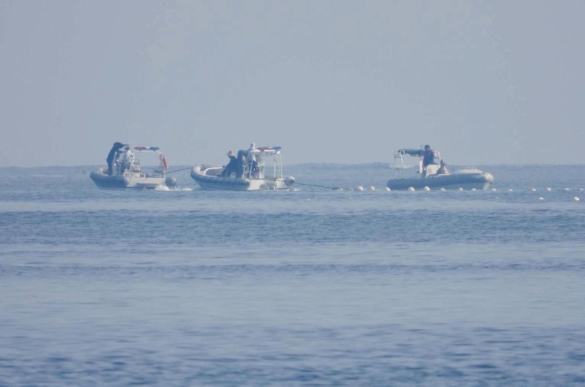 A handout photo made available by Philippine Coast Guard (PCG) shows Chinese Coast Guard boats patrolling next to a floating barrier at the vicinity of Scarborough Shoal in the disputed South China Sea on 20 September 2023 (issued on 25 September 2023). EFE-EPA/HO HANDOUT HANDOUT EDITORIAL USE ONLY/NO SALES