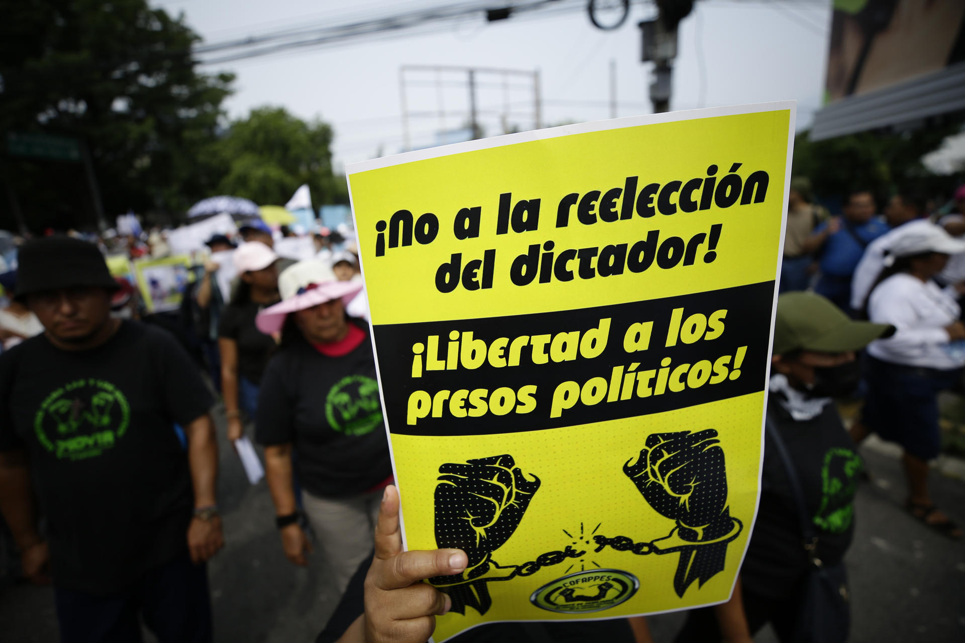 Unions, civil society organizations, students and human rights representatives march in commemoration of International Labor Day, in San Salvador, El Salvador, on May 1, 2023, with this sign reading "No to the re-election of the dictator." EFE FILE/Rodrigo Sura
