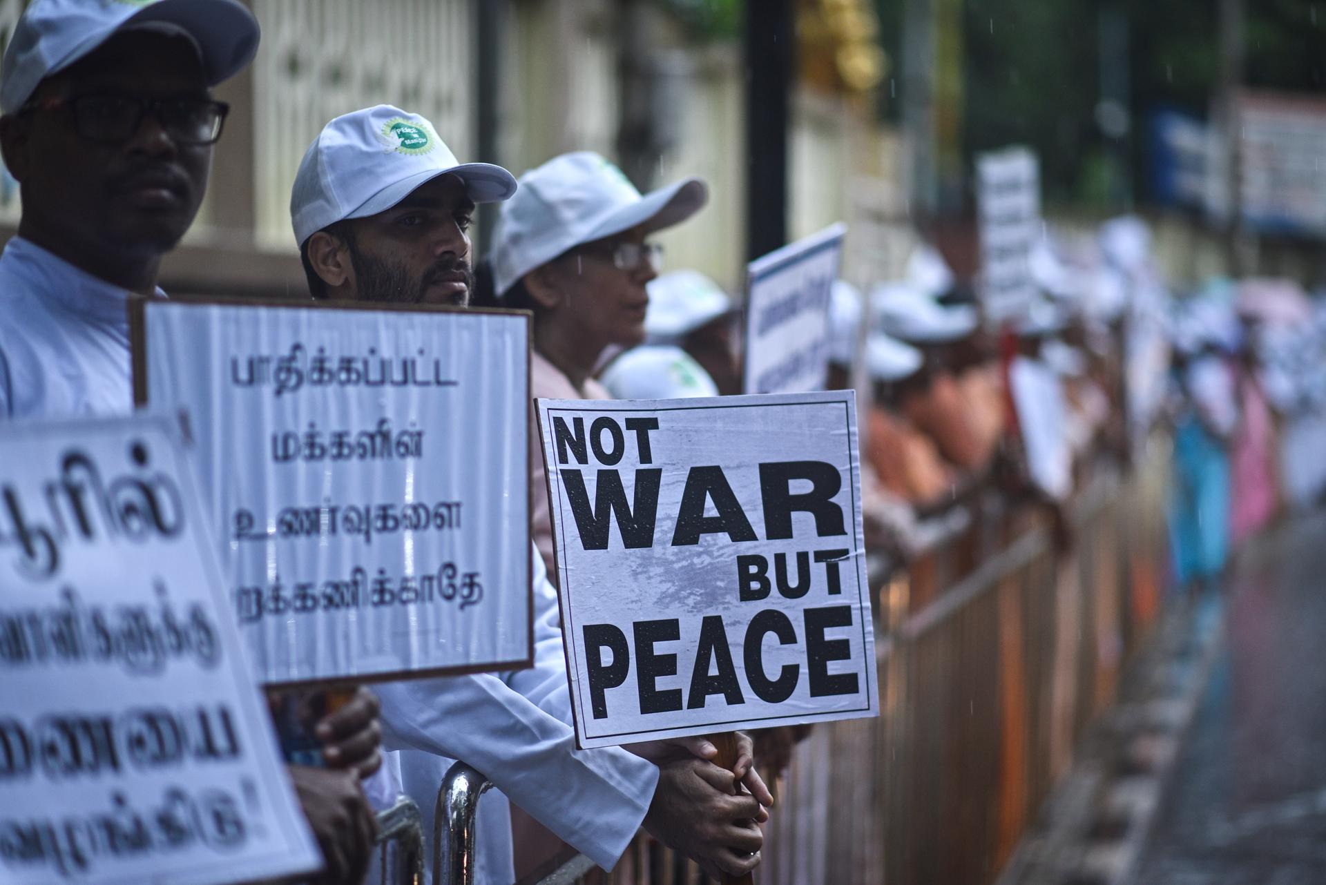 Members of the Christian community hold placards as they take part in a protest rally for peace in the violence-hit northeastern Manipur state and against the ongoing conflict between two ethnic groups, Kukis and Meiteis, at Santhome Cathedral Basilica, in Chennai, India, 16 September 2023. EFE-EPA/IDREES MOHAMMED