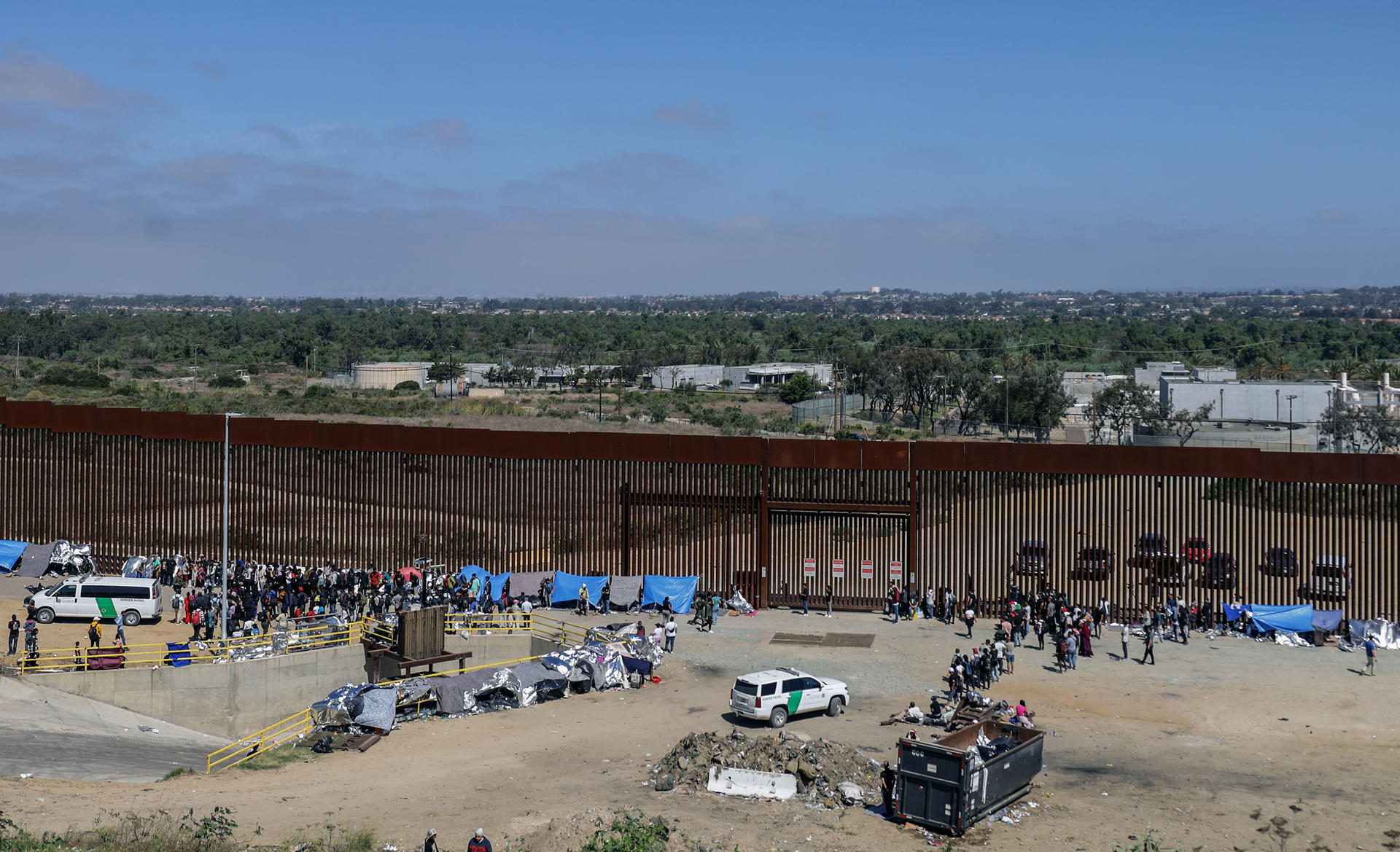 Migrants stand next to the border fence on September 13, 2023, in the city of Tijuana, Baja California, Mexico. EFE/Joebeth Terríquez