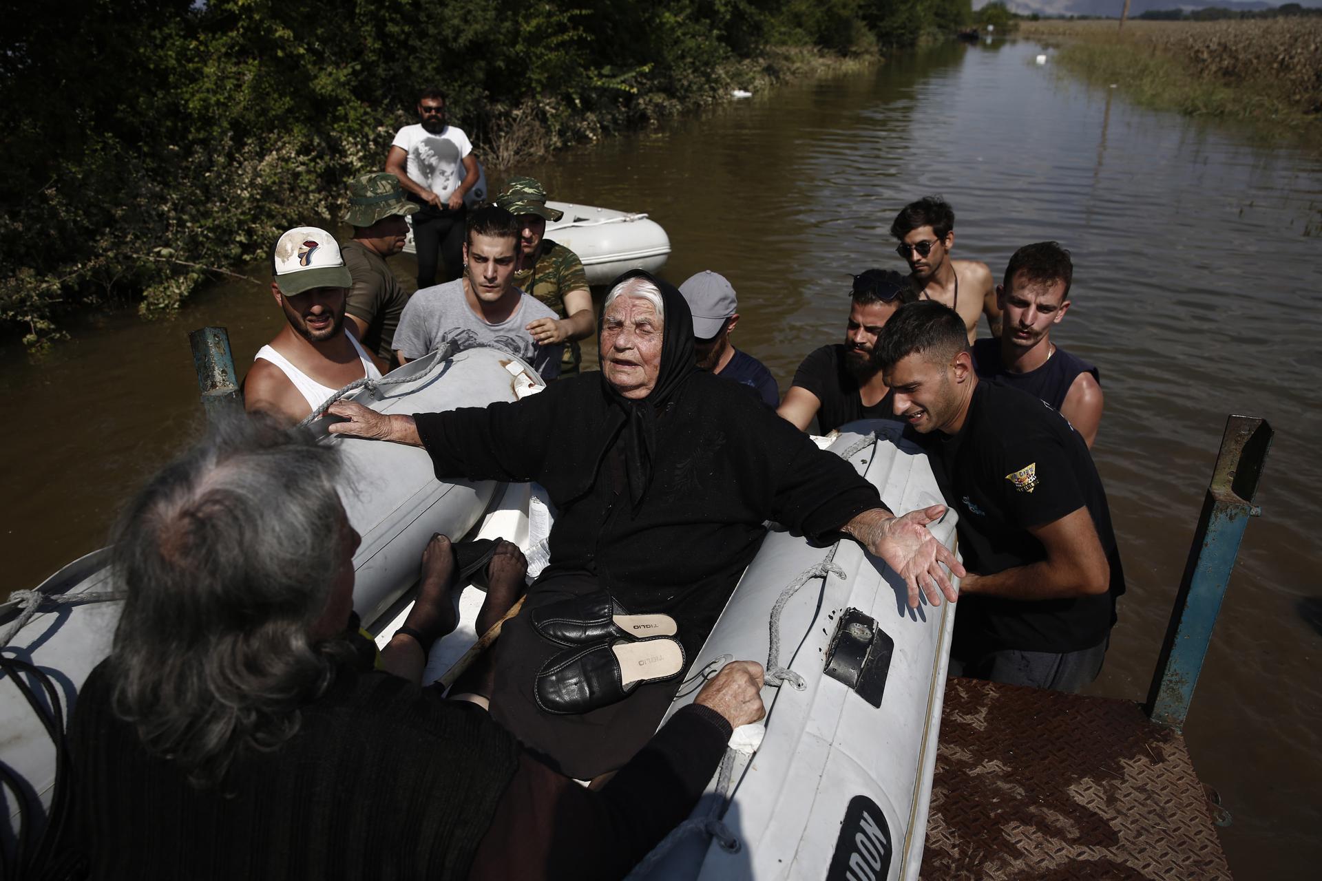A rescue team helps flood-stranded people on a rubber boat in an area near Koskina in Karditsa, Greece, 09 September 2023 (Issued 10 September 2023). EFE/EPA/YANNIS KOLESIDIS