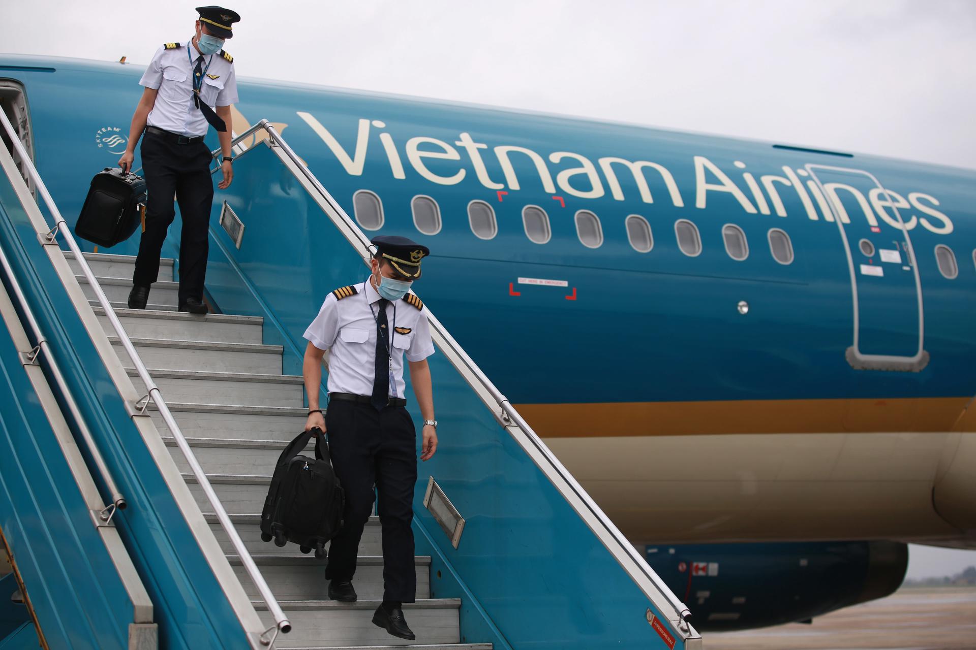 Pilots disembark a Vietnam Airlines airplane arriving from Taiwan, at Noi Bai International Airport in Hanoi, Vietnam 03 March 2020. EFE-EPA FILE/LUONG THAI LINH