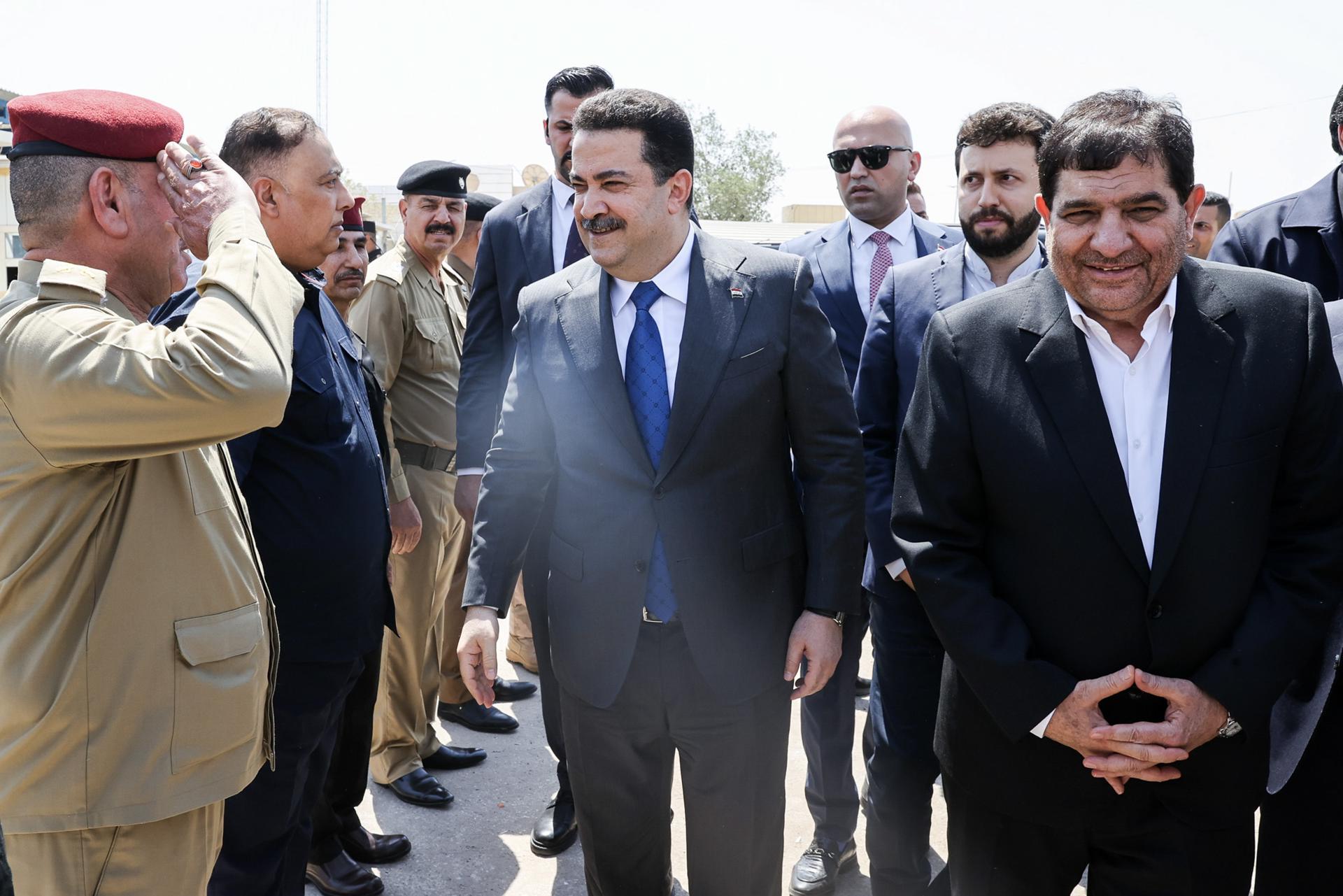 A handout picture made available by the Iranian Vice Presidency shows Iranian Vice President Mohammad Mokhber (R) and Iraqi Prime Minister Mohammed Shia' al-Sudani (C) greeting officials on the sidelines of an unveiling ceremony to launch the construction of the joint Shalamcheh-Basra railway project, at the Shalamcheh-Basra border crossing in the southern province of Basra, in Basra, Iraq, 02 September 2023 (issued 03 September 2023). EFE-EPA/IRANIAN VICE PRESIDENCY / HANDOUT HANDOUT EDITORIAL USE ONLY/NO SALES