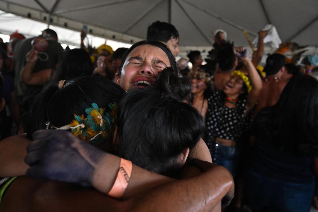 Indigenous people celebrate the favorable vote during the transmission of the Temporary Framework trial on a screen installed in front of the Supreme Federal Court, in Brasilia, Brazil, on September 21 2023. EFE/ Andre Borges
