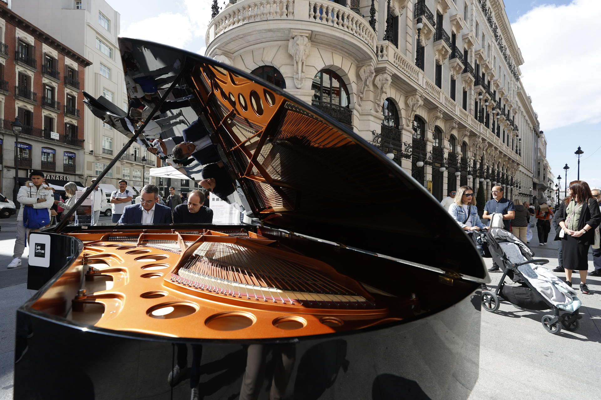 Una pianista toca un piano de cola en la Plaza de Sol en Madrid este viernes durante la iniciativa Pianos por Madrid. EFE/ Javier Lizón