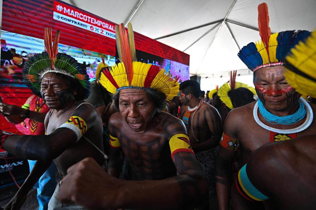 Indigenous people celebrate the favorable vote during the transmission of the Temporary Framework trial on a screen installed in front of the Supreme Federal Court, in Brasilia, Brazil, on September 21 2023. EFE/Andre Borges

