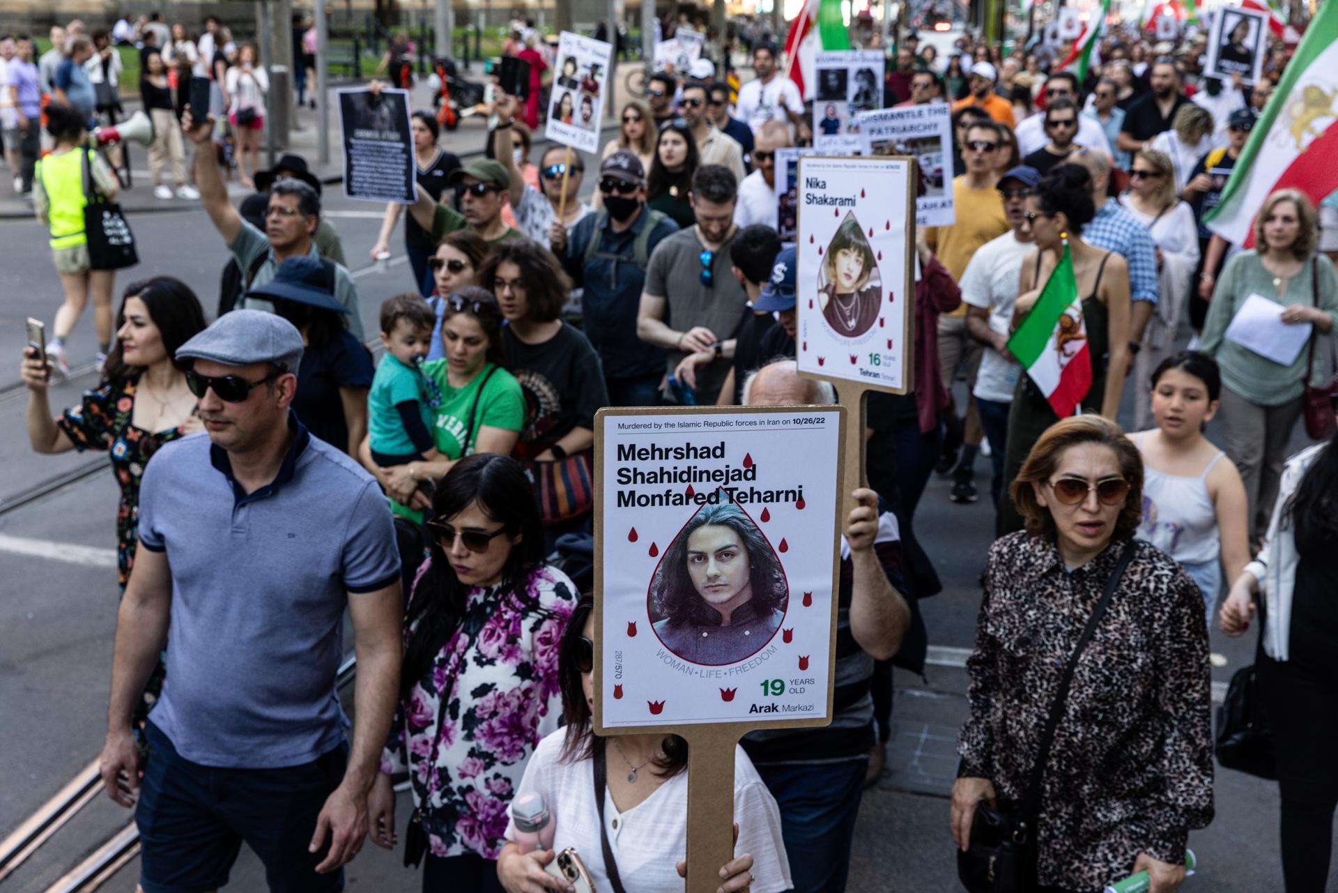 Protesters hold placards and flags during a rally marking the one-year anniversary of Mahsa Amini's death in custody, along Swanston Street, in Melbourne, Australia, 16 September 2023. EFE-EPA/DIEGO FEDELE AUSTRALIA AND NEW ZEALAND OUT