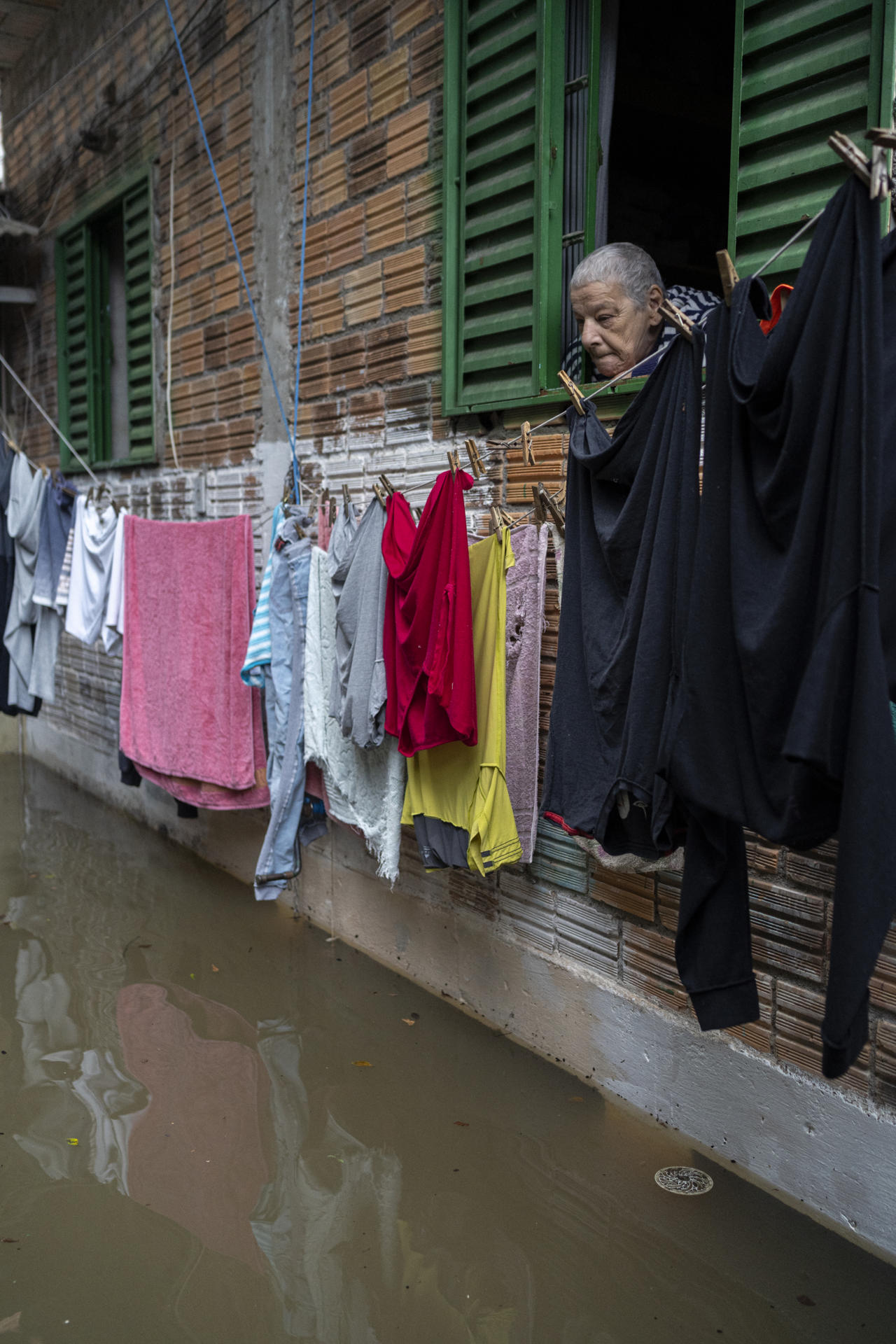 A woman looks at the damage to her home after the overflow of Lake Guaiba, given the heavy rains in Porto Alegre, Rio Grande do Sul, Brazil, 27 September 2023. The rains in the south of Brazil do not let up and after the tragedy they caused at the beginning of the month amid the passage of an extratropical cyclone. The authorities' alarms were raised again this Wednesday, due to the overflow of a lake located in the heart of the metropolitan area of Porto Alegre. According to Civil Defense data, the level of Lake Guaiba exceeded the limit by 17 centimeters and overflows have already been registered in some areas of the capital of Rio Grande do Sul. EFE/ Daniel Marenco