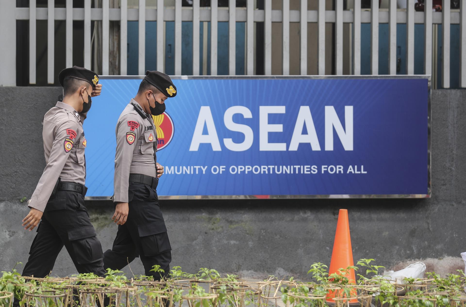 Police officers walk past the Association of Southeast Asian Nations (ASEAN) logo outside the ASEAN secretariat as vehicles of the delegates enter the compound ahead of the special ASEAN foreign ministers' meeting in Jakarta, Indonesia, 27 October 2022. EFE-EPA FILE/BAGUS INDAHONO