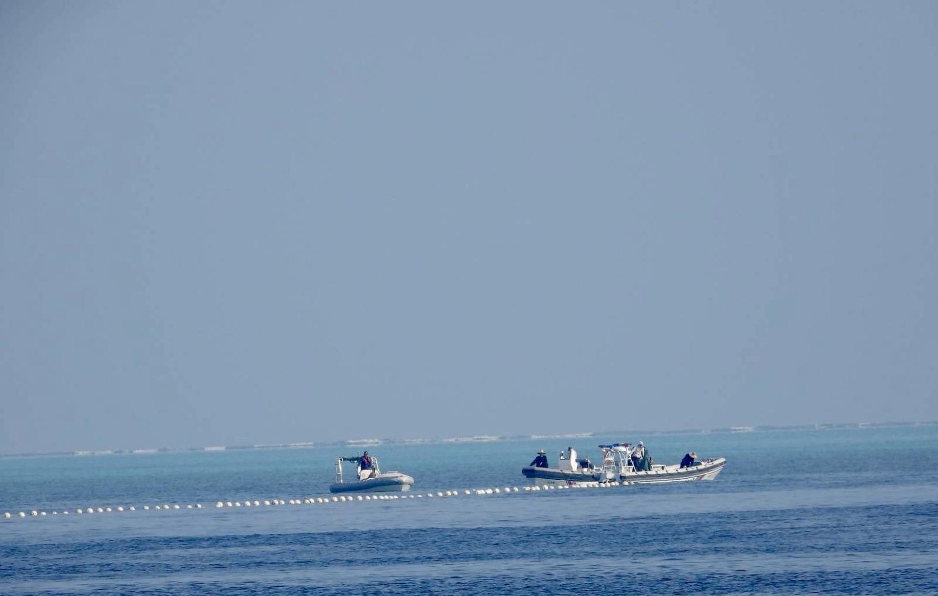 A handout photo made available by Philippine Coast Guard (PCG) shows Chinese Coast Guard boats patrolling next to a floating barrier at the vicinity of Scarborough Shoal in the disputed South China Sea on 20 September 2023 (issued on 25 September 2023). EFE/EPA/HO HANDOUT HANDOUT EDITORIAL USE ONLY/NO SALES
