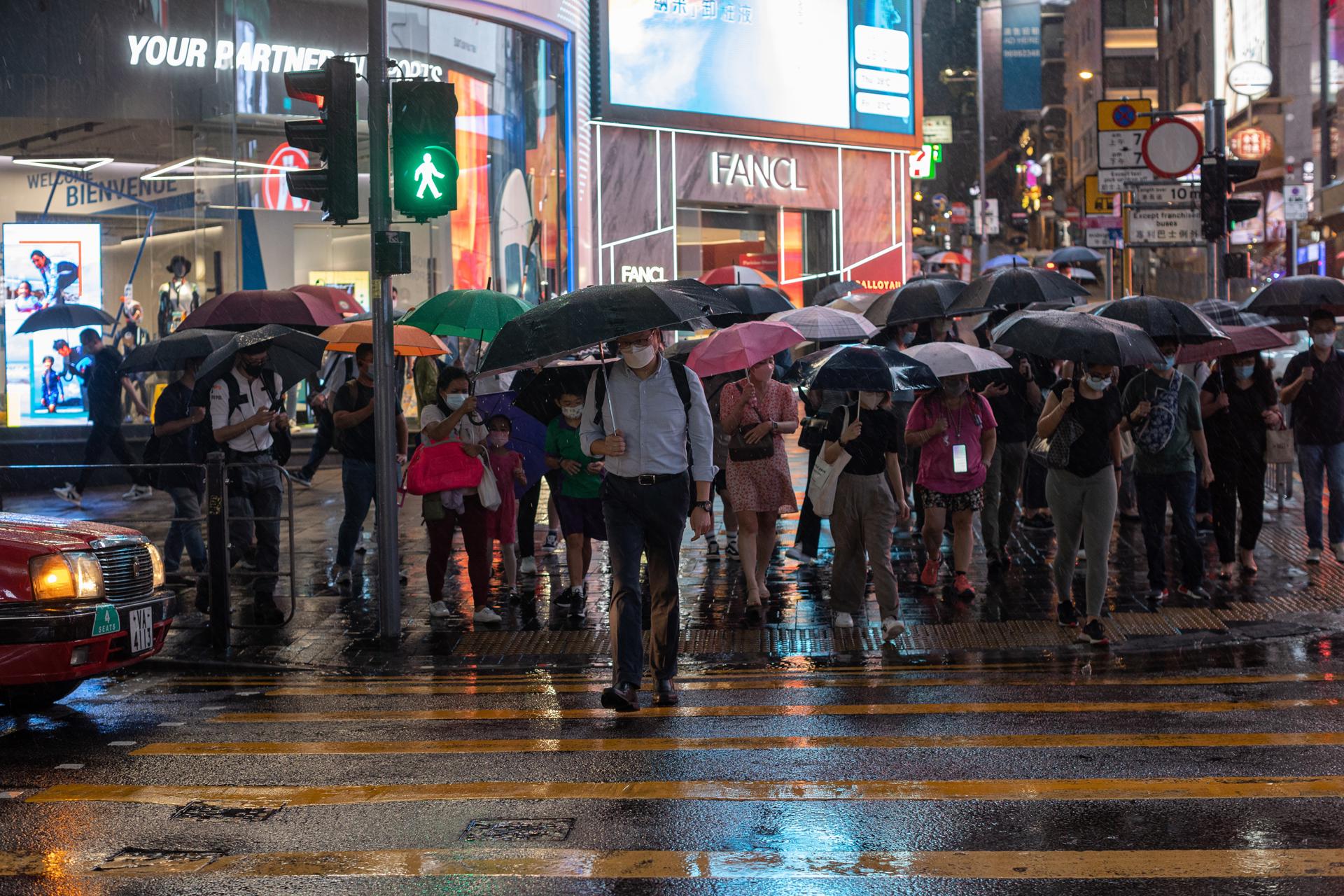 Pedestrians cross an intersection under a pouring rain in Hong Kong, China, 15 June 2022. EFE-EPA FILE/JEROME FAVRE
