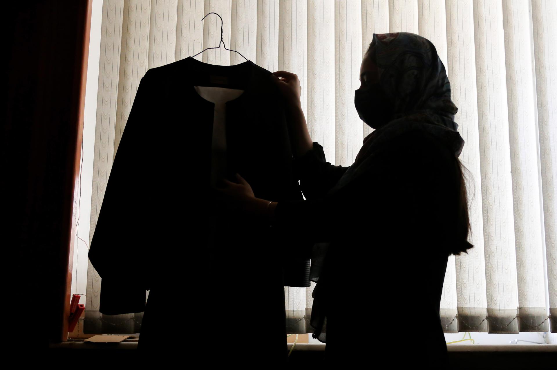 Kabul (Afghanistan), 18/09/2023.- Zahra, a 16-year-old 10th grade student, holds her school uniform at her home as she marks the second anniversary of ban on girls going to higher secondary schools, in Kabul, Afghanistan, 18 September 2023. (Afganistán) EFE/EPA/SAMIULLAH POPAL