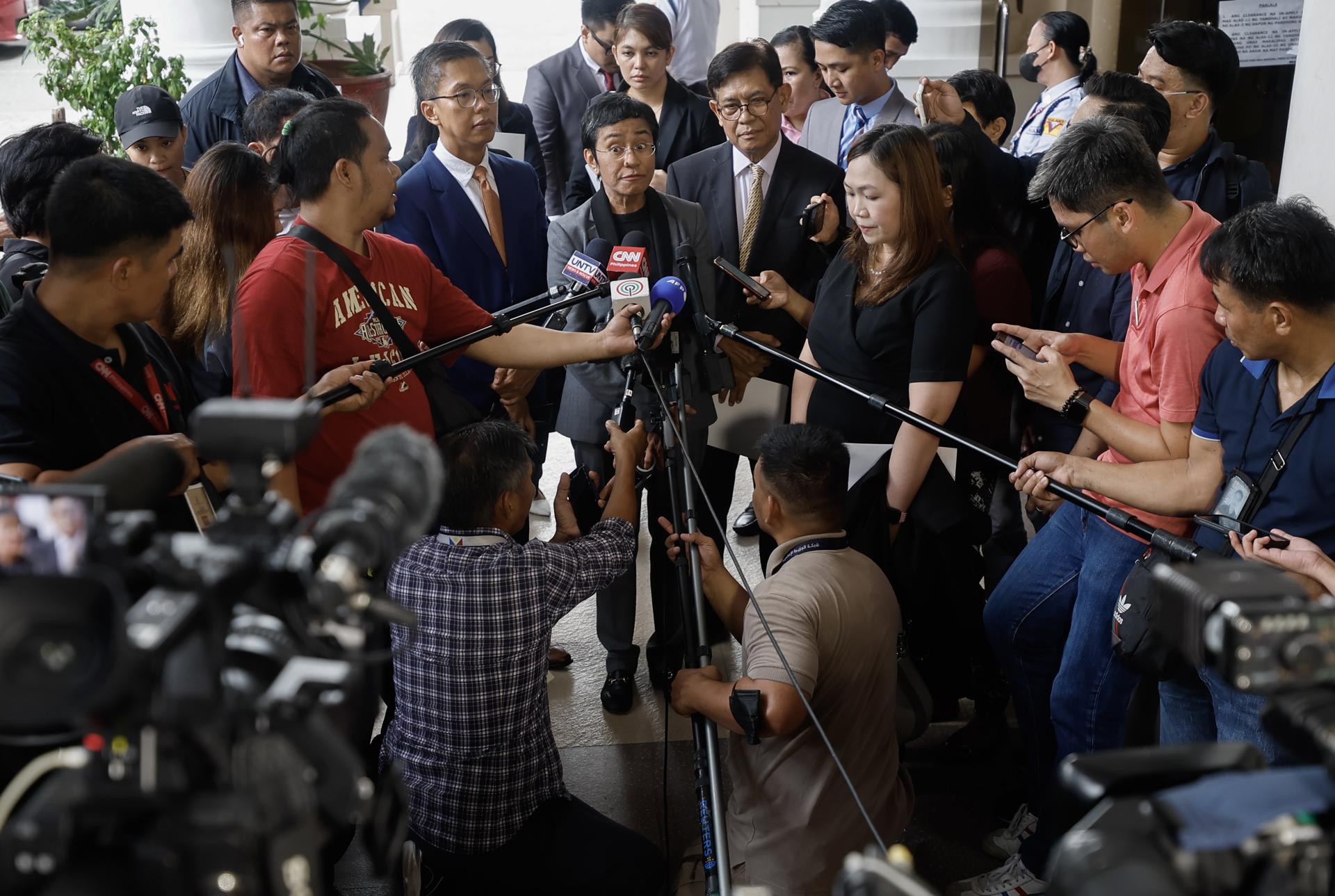 Nobel Peace Prize laureate Maria Ressa (C), the CEO of online news site Rappler, talks to journalists outside the regional trial court in Pasig City, Metro Manila, Philippines, 12 September 2023. EFE-EPA/ROLEX DELA PENA
