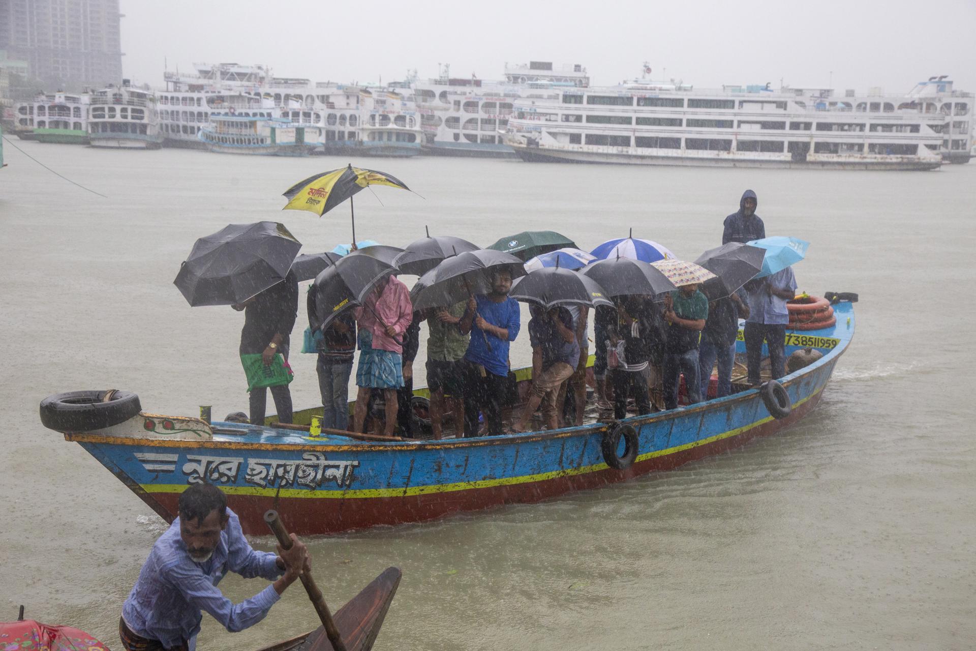 A file picture of passengers cross a river during a heavy rain in Dhaka, Bangladesh. EFE/EPA/FILE/MONIRUL ALAM
