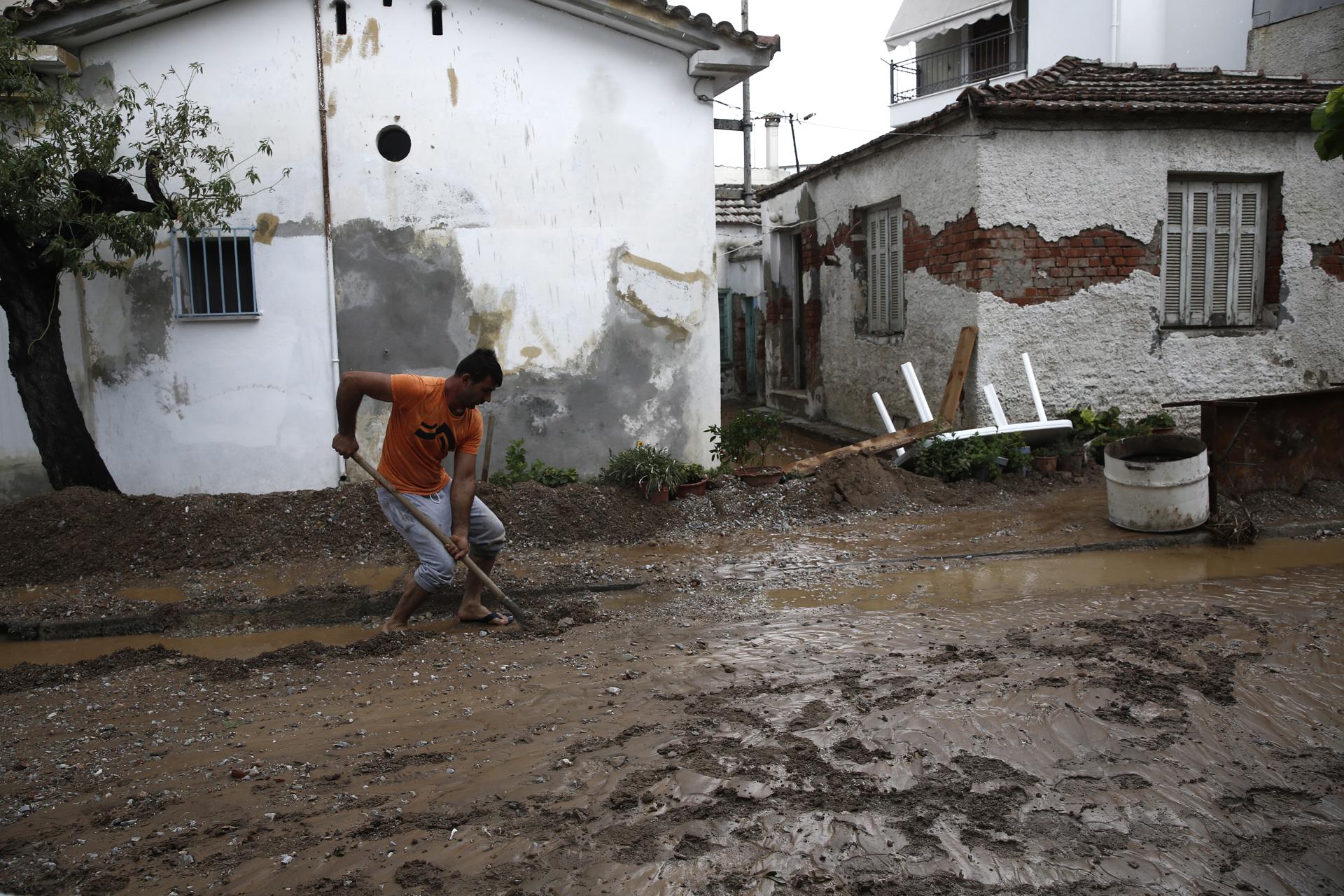 (FILE) A man tries to clean mud from a road during the storm named Daniel, in Agria village of Volos, Magnesia, Greece, 06 September 2023. EFE/EPA/YANNIS KOLESIDIS