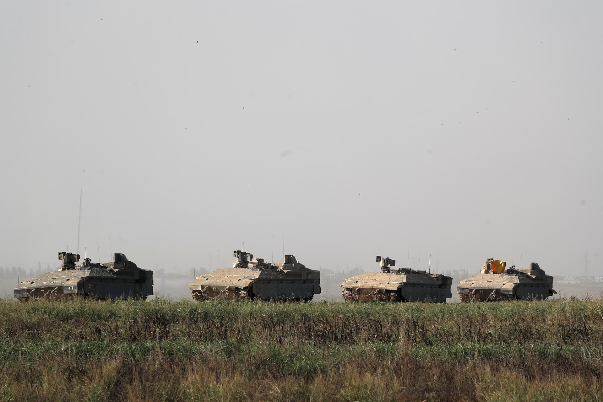 IDF 'Namer' armoured personnel carriers (APCs) maneuver at an area along the border with Gaza, southern Israel, 13 October 2023. EFE-EPA/ATEF SAFADI