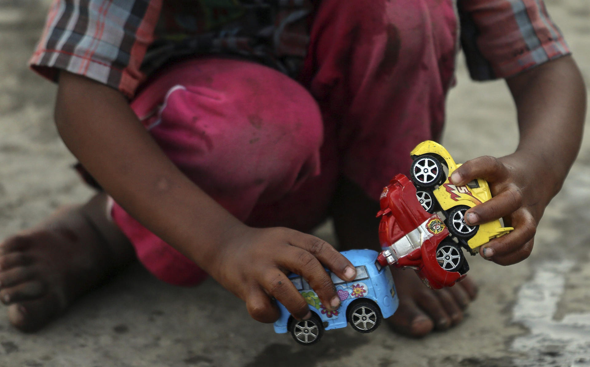 A child of a farmer from the drought affected districts of Maharashtra plays with the toy car at a temperory refugee camp in Mumbai, India, 26 April 2016. EPA-EFE FILE/DIVYAKANT SOLANKI
