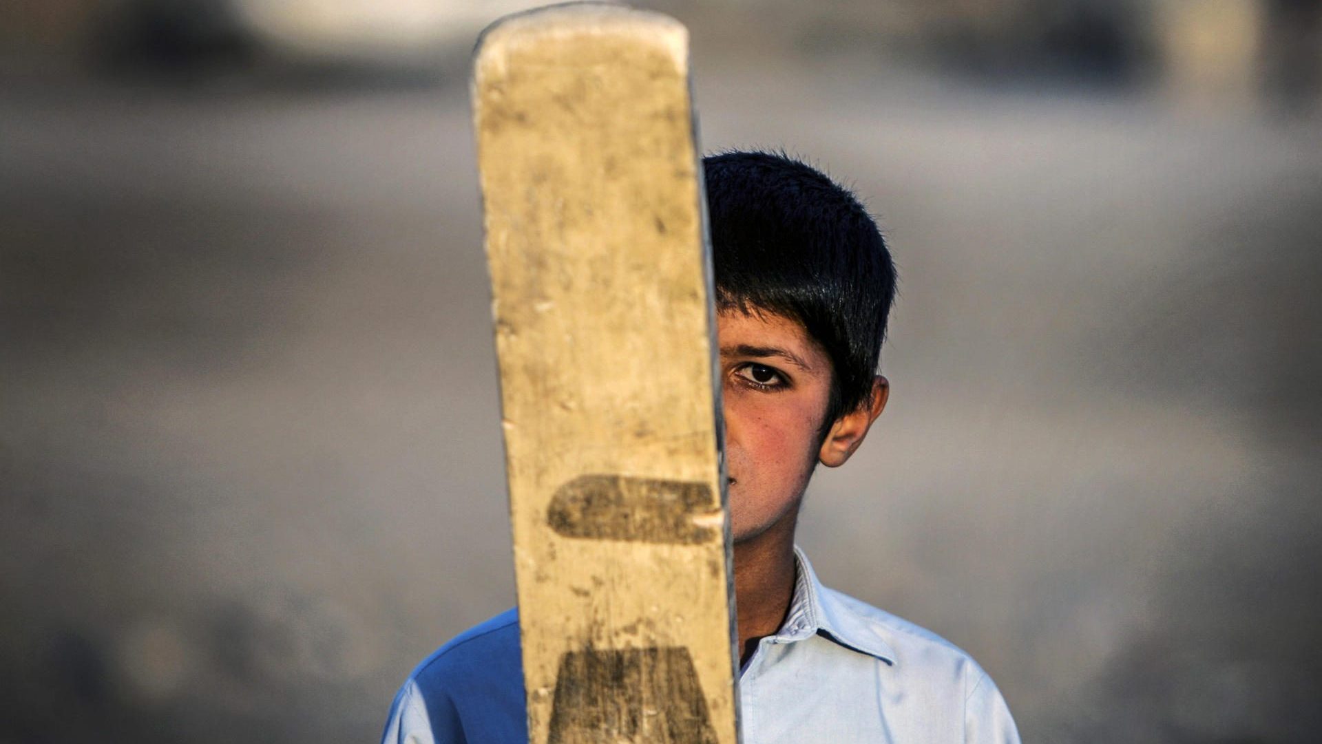 A young Afghan plays cricket on the outskirts of Kabul, Afghanistan, 15 January 2015. EPA/FILE/HEDAYATULLAH AMID