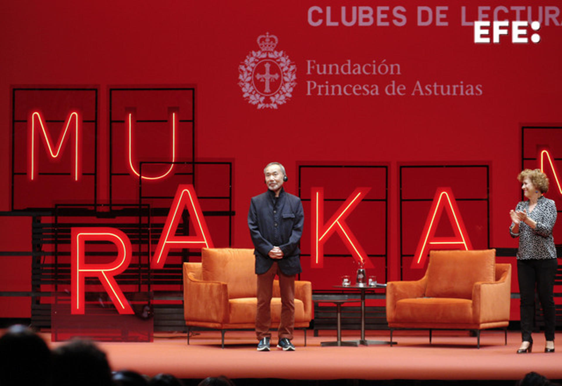 Japanese writer Haruki Murakami (C) and Spanish writter and journalist Berna Gonzalez Harbour (D) during a meet with readers clubes members at the Jovellanos Theatre in Gijon, northern Spain, 18 October 2023. EFE/Juan Gonzalez