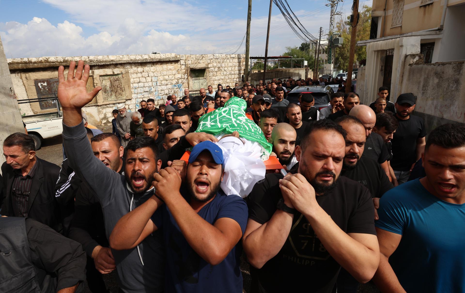Palestinian mourners carry the body of 16-year-old Mohamed Odwan during his funeral at Faroun village near the West Bank city of Tulkarem, 15 October 2023. EFE-EPA/FILE/ALAA BADARNEH