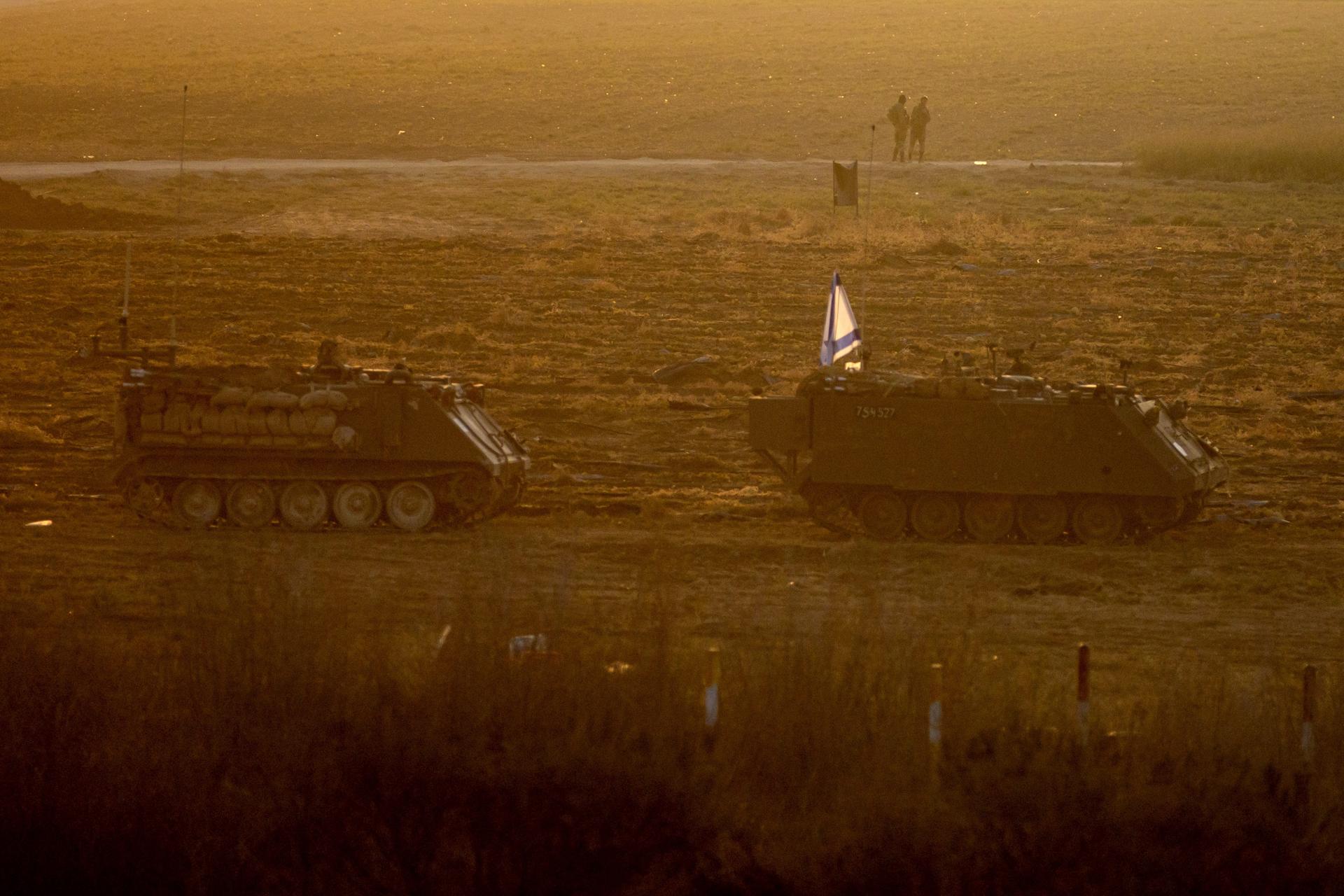 Israeli soldiers stand next to armored vehicles sitting in an area along the border with Gaza, southern Israel, 14 October 2023. EFE-EPA/MARTIN DIVISEK
