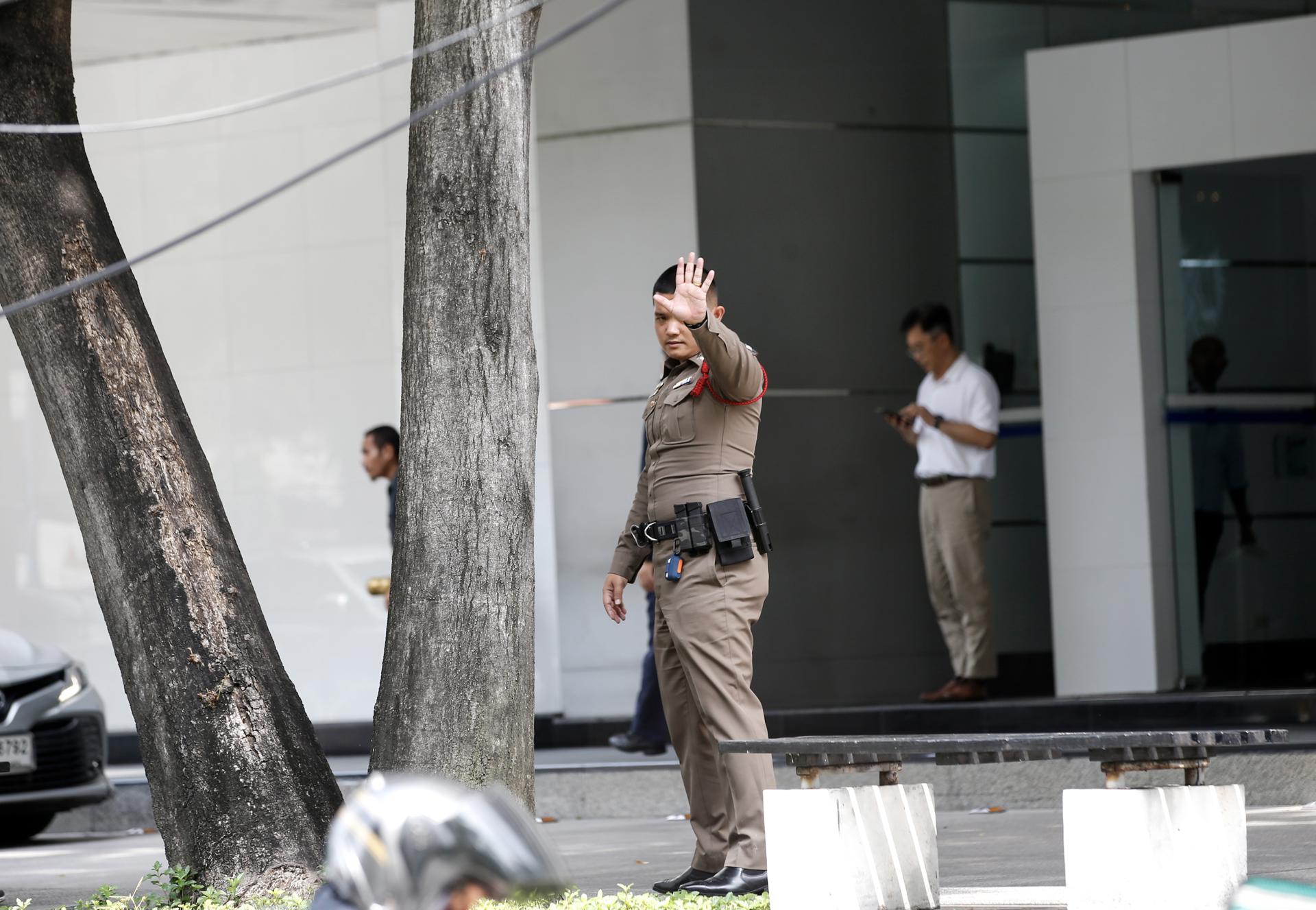 A Thai police officer reacts during a security patrol outside a building where the Israeli embassy is located in Bangkok, Thailand, 09 October 2023. EFE-EPA/RUNGROJ YONGRIT
