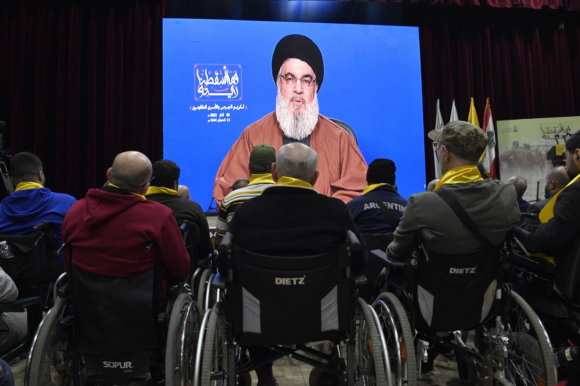 Injured members of Hezbollah listen to a speech by Hezbollah leader Sayyed Hassan Nasrallah delivered on a big screen during a rally to commemorate Hezbollah 'Wounded Resistance Day' in the southern suburb of Beirut, Lebanon, 06 March 2023. EFE-EPA FILE/WAEL HAMZEH
