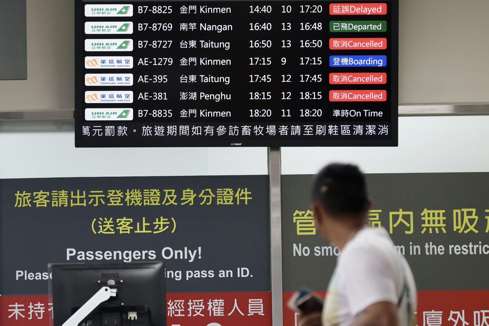 A passenger checks cancelled flight status as Typhoon Koinu moves closer toward southern Taiwan, inside the Songshan airport in Taipei, Taiwan, 04 October 2023. EFE-EPA/RITCHIE B. TONGO