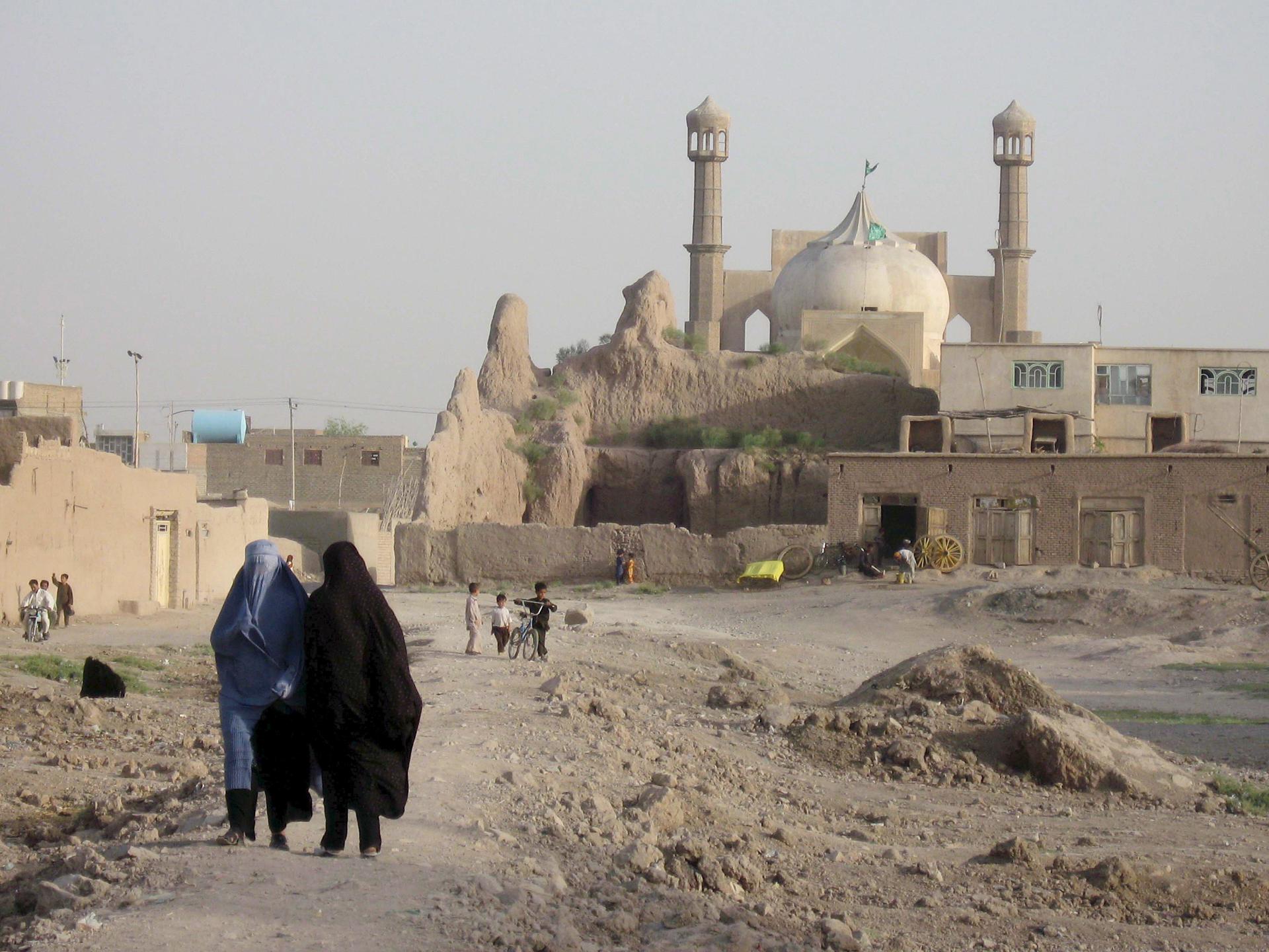 A file picture shows two Afghan women leaving the sanctuary of Sultan Aqa in Herat (Afghanistan). EFE-FILE/Jalil Rezayee
