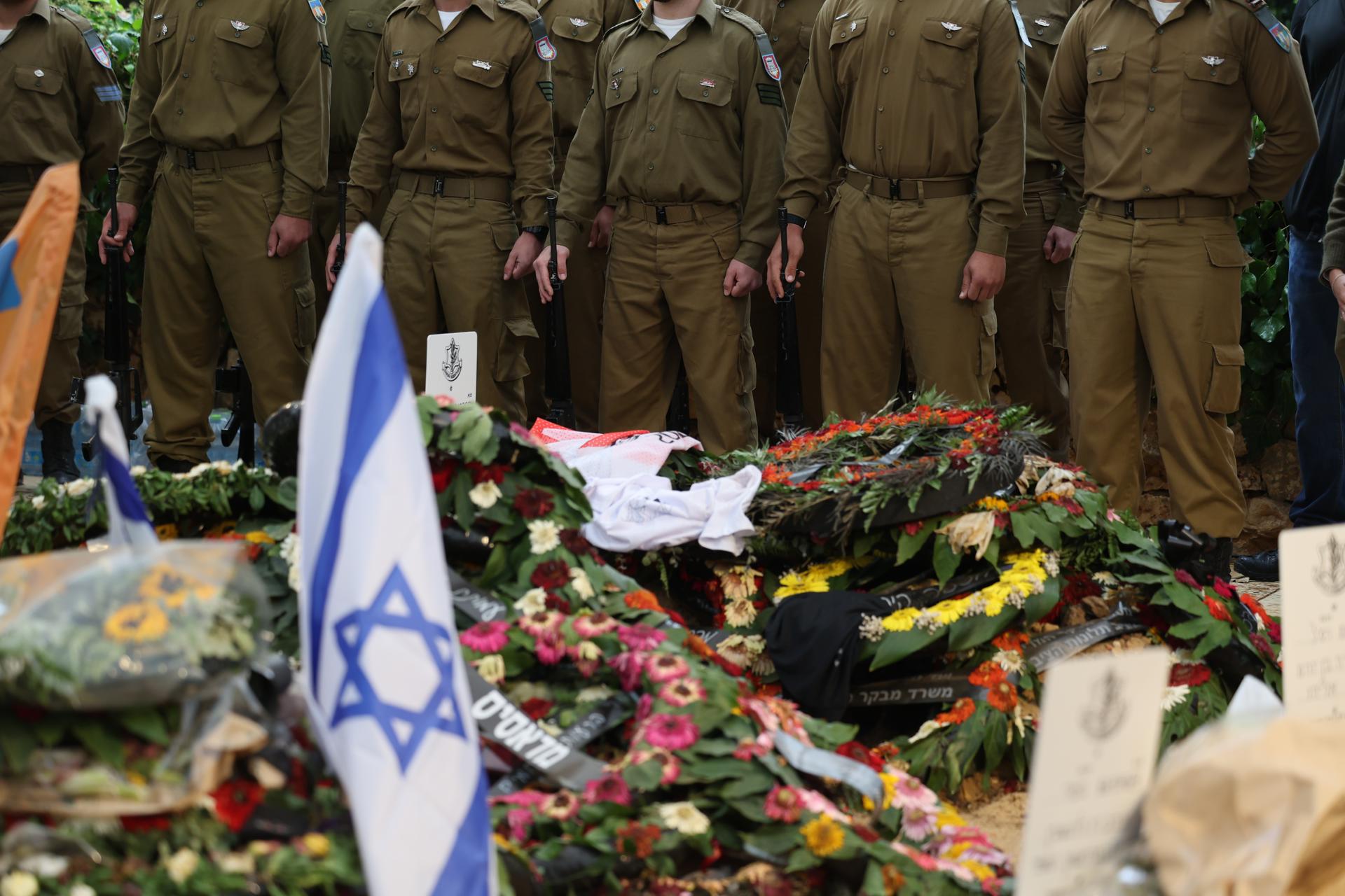 File picture dated 19 November 2023 of Israeli soldiers standing as honor guard during the funeral of a comrade at the Mount Herzl military cemetery in Jerusalem. EFE/EPA/ABIR SULTAN
