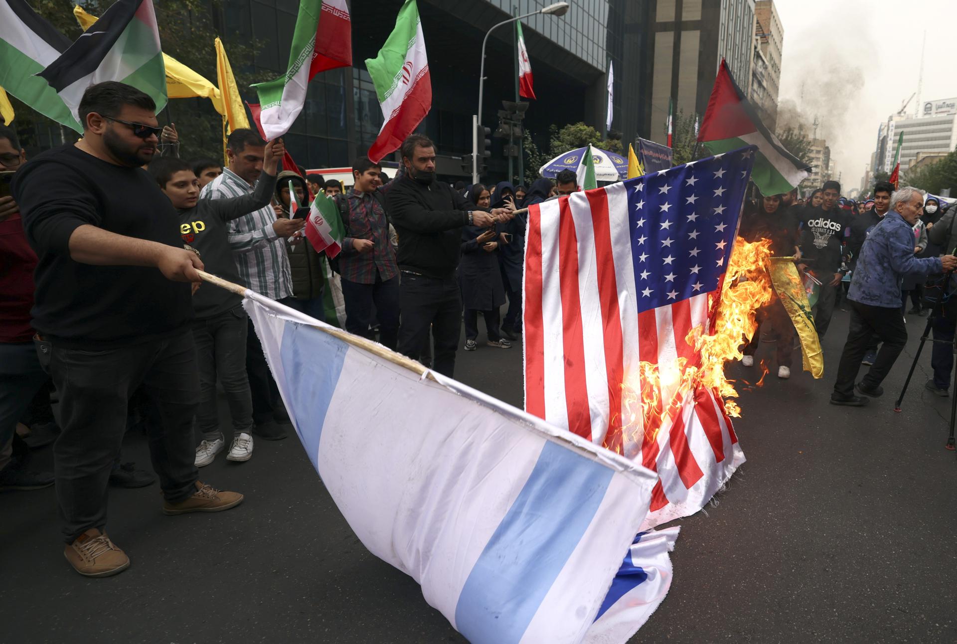 Iranians burn US and Israel flags during an anti-US rally marking the 44th anniversary of the US Embassy takeover, in front of the former embassy building in Tehran, Iran, 04 November 2023. EFE-EPA FILE/ABEDIN TAHERKENAREH
