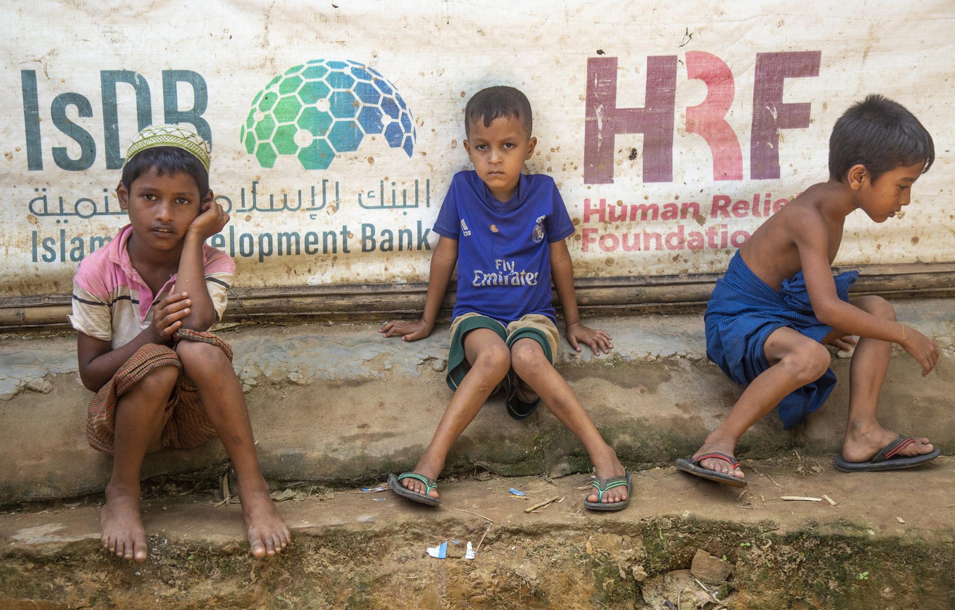 Rohingya refugee children sit during a protest held to mark the five year anniversary of the mass migration of Rohingya refugees from Myanmar to Bangladesh, at a makeshift camp in Kutubpalang, Ukhiya, Cox Bazar district, Bangladesh, 25 August 2022. EFE-EPA FILE/MONIRUL ALAM
