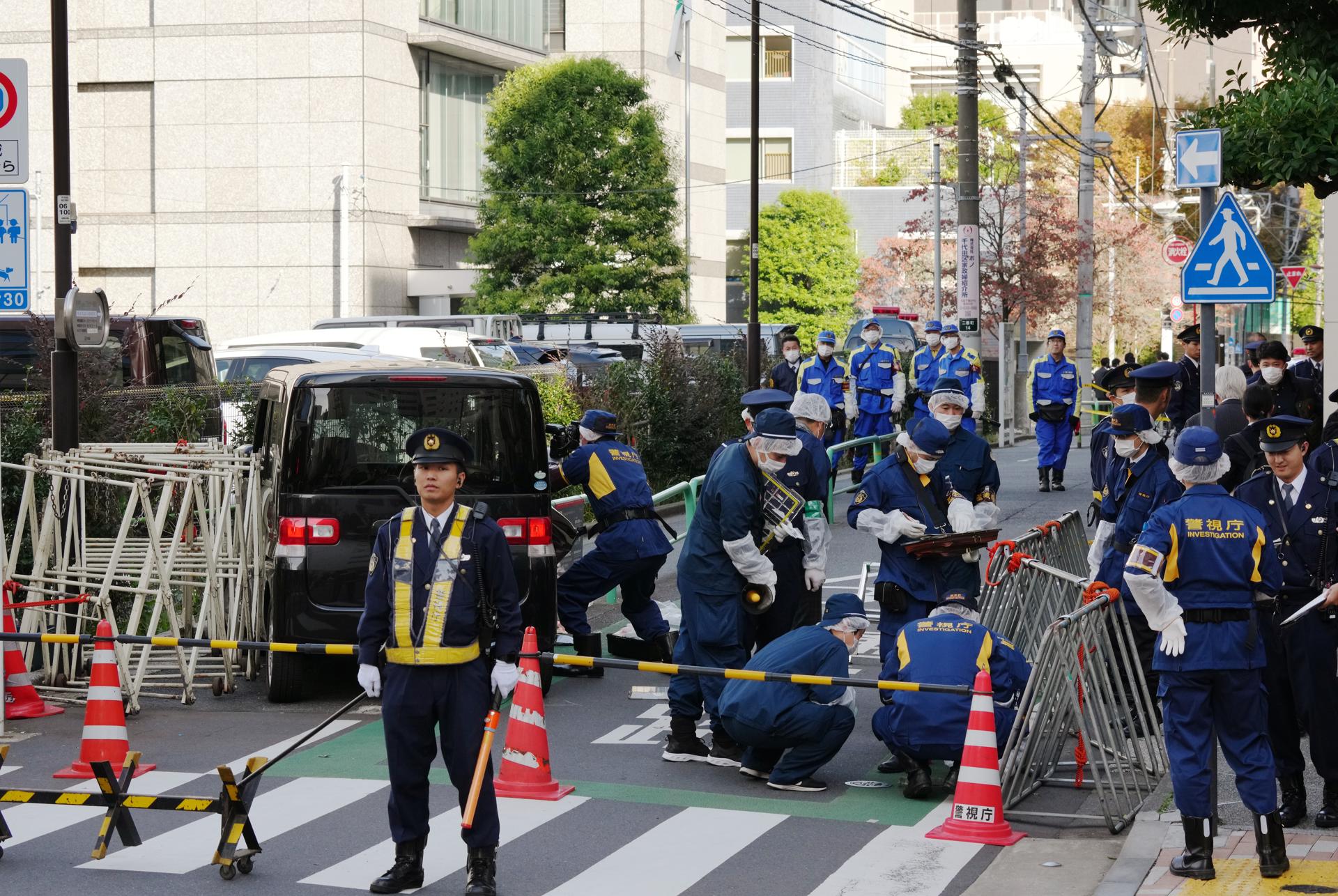 Japanese policemen investigate the scene after a driver crashed a car into a police barricade near the Israel Embassy, in Tokyo, Japan, 16 November 2023. EFE-EPA/KIMIMASA MAYAMA
