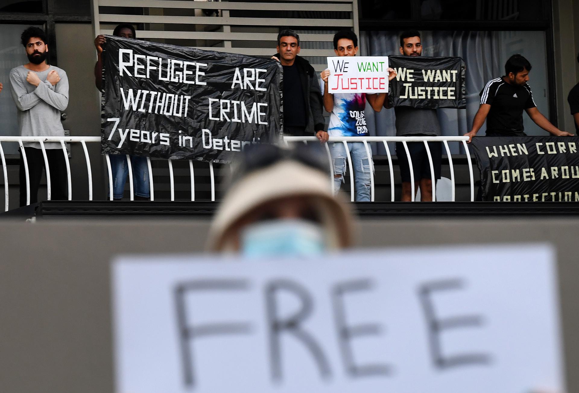 A refugee supporter holds up a sign as asylum seekers, who are being held in detention, protest at an inner city motel in Brisbane, Australia, 08 May 2020. EFE-EPA FILE/DAN PELED AUSTRALIA AND NEW ZEALAND OUT
